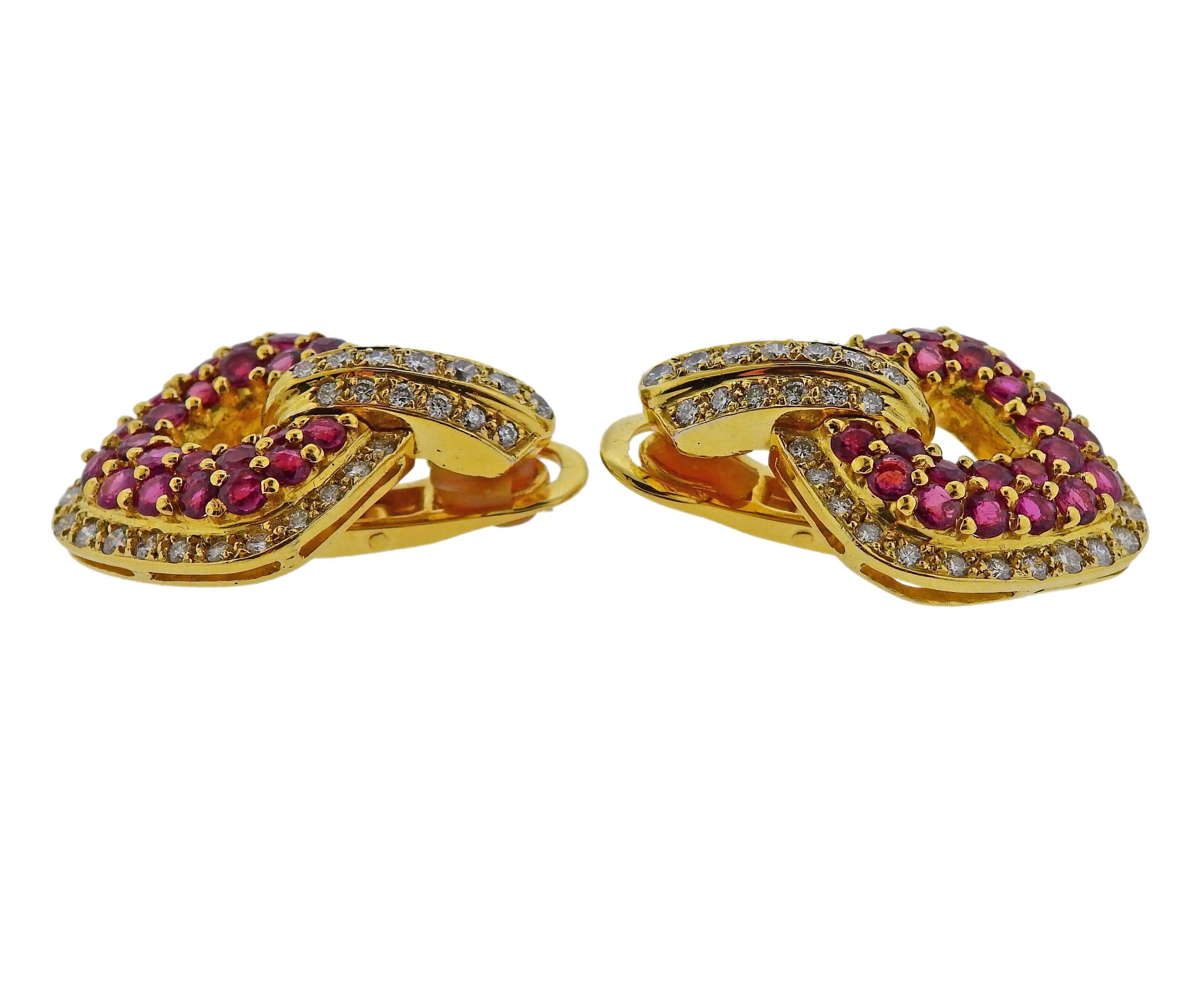 Pair of 18k yellow gold cocktail earrings, set with rubies and approx. 1.20ctw in diamonds. Earrings are 32mm x 25mm. Marked 750. Weigh 24.8 grams. 