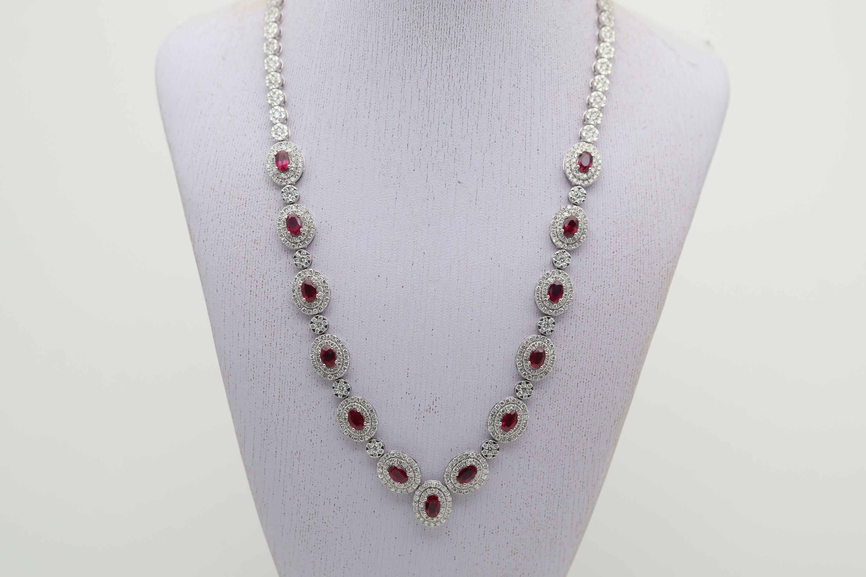 A stunning dinner necklace studded with fine gems and diamonds! The necklace features 13 fine oval-shaped rubies weighing 7.85 carats. They are all perfectly matching in shape size and color, as they all have a rich vivid red color. Adding to the