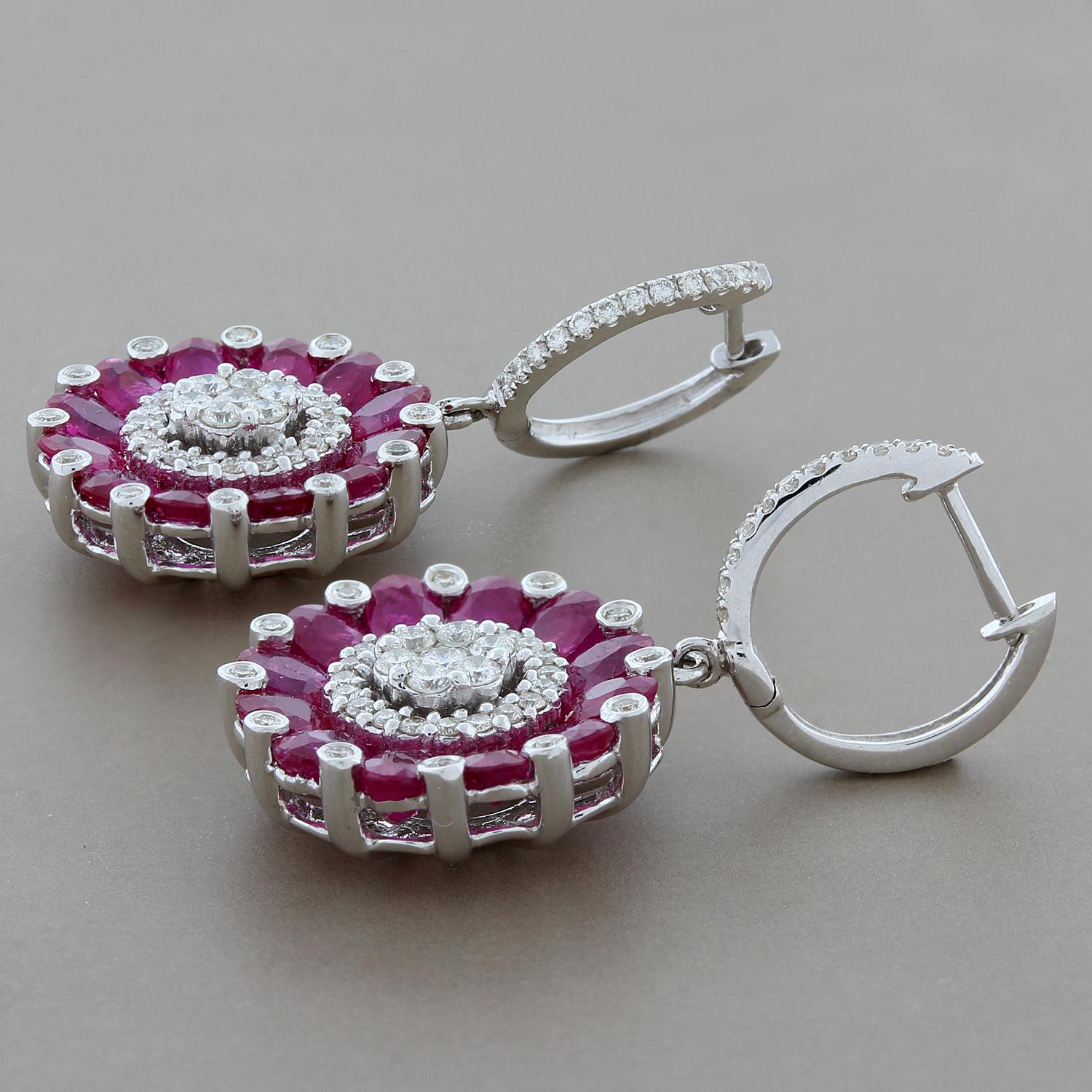 This pair of earrings are fun and glamorous! They feature 4.26 carats of oval cut rubies and 0.76 carats of VS quality round cut diamonds set in 18K white gold. Can be worn everyday or for a night out.

Earring Length: 1.25 inches
Earring Width: