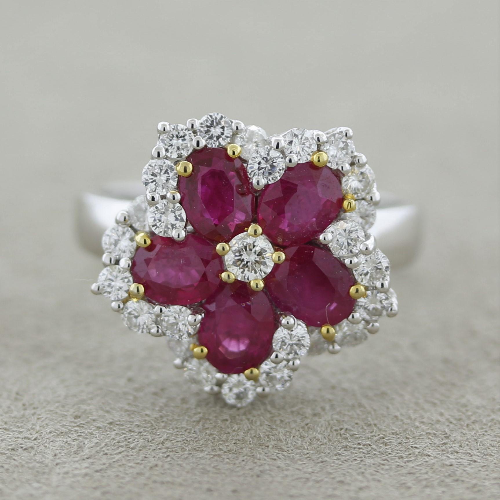 A lovely gemstone ring featuring 5 vivid red oval shaped rubies weighing 2.10 carats. They are set in a flower pattern with 0.76 carats of round brilliant-cut diamonds set on its edges giving the ring brilliance and sparkle. Made in 18k white gold