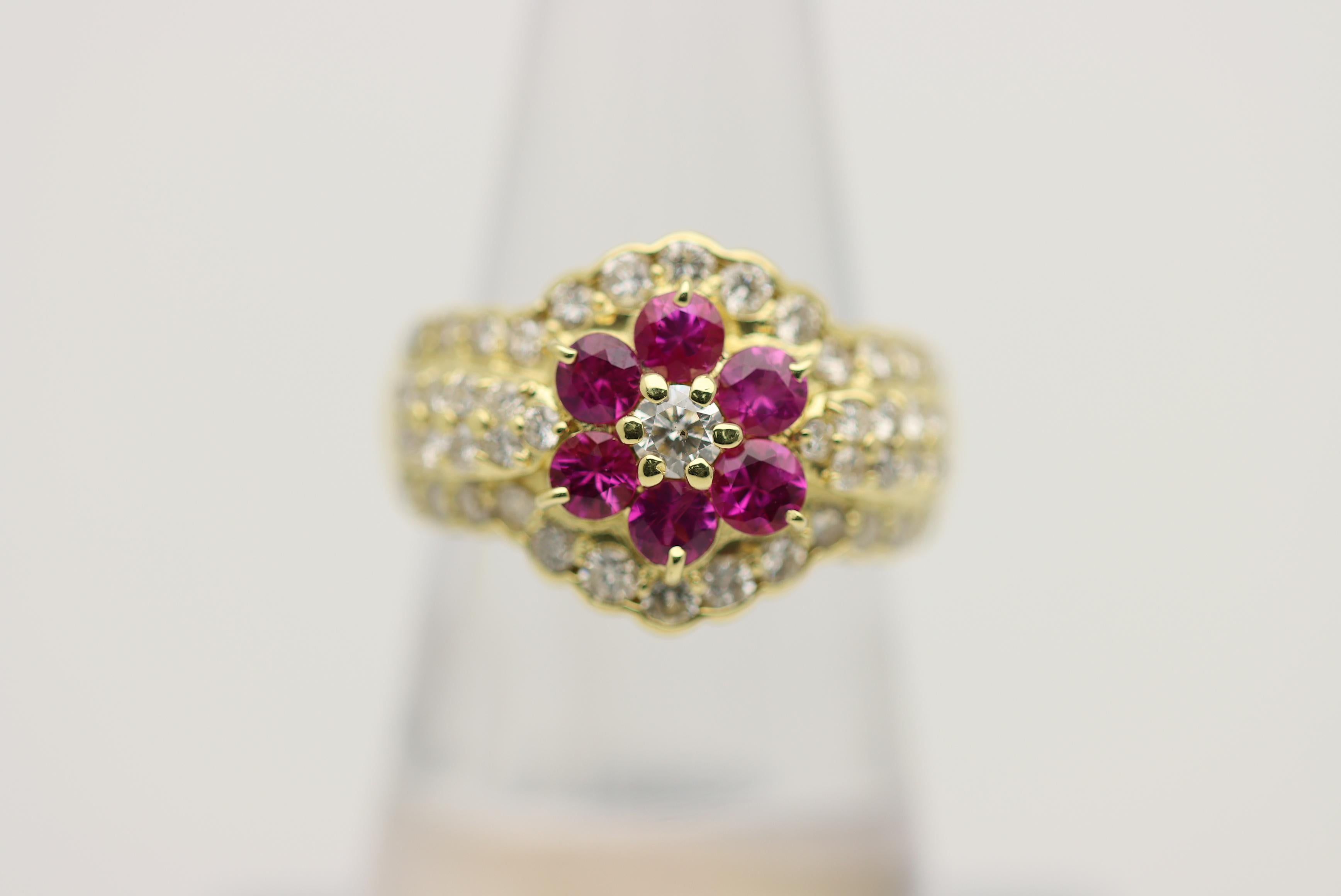 A sweet and stylish ring featuring 1.17 carats of vivid red rubies set in a flower pattern. It is further accented by 1.16 carats of round brilliant-cut diamonds creating adding sparkle and brilliance to the piece. Made in 18k yellow gold and ready