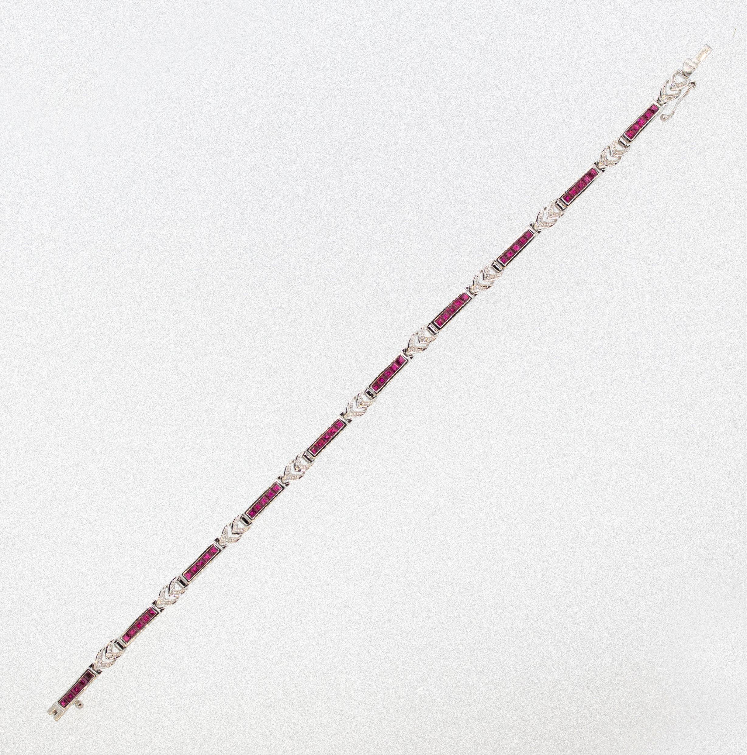 A sweet bracelet featuring 3.27 carats of calibre cut rubies which are channel set. They are accented by 0.11 carats of round cut diamonds set in gold arrows between the sets of rubies. Made in 18k white gold.

Length: 7.5 inches