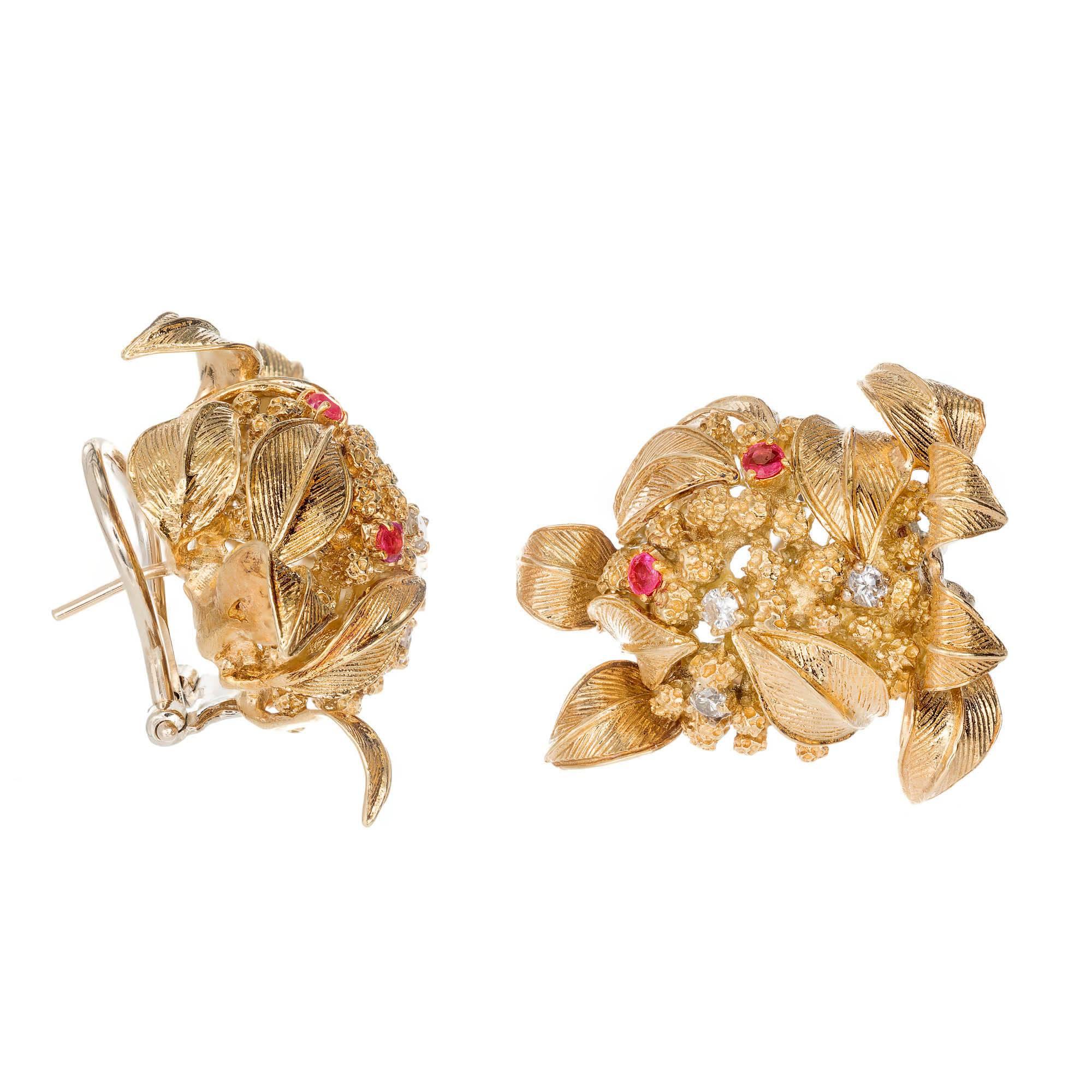Three dimensional handmade 18k solid gold clip post earrings. All hand textured and detailed. Set with full cut diamonds and bright red Rubies.

4 natural red untreated Rubies 2mm, approx. total weight .20cts.
6 round diamonds approx. total weight