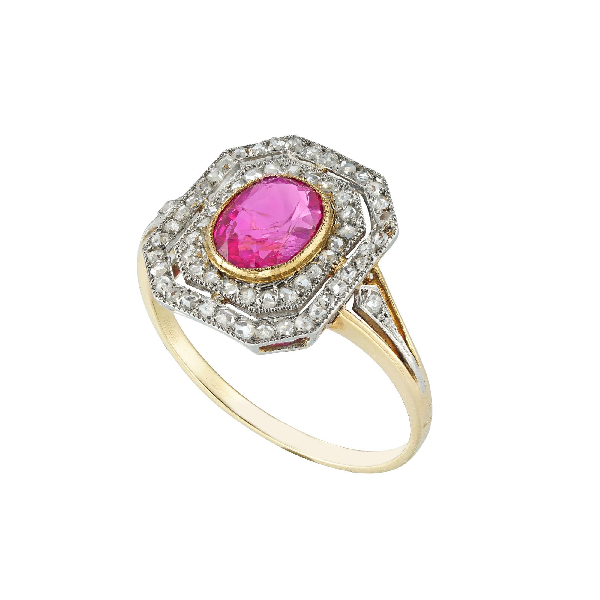 A ruby and diamond tablet cluster ring, the oval ruby measuring approximately 7.2 x 5.6mm, estimated to weigh 1.2 carats, in a gold millegrain setting surrounded by a double border of rose-cut diamonds with a daylight in-between to a platinum mount