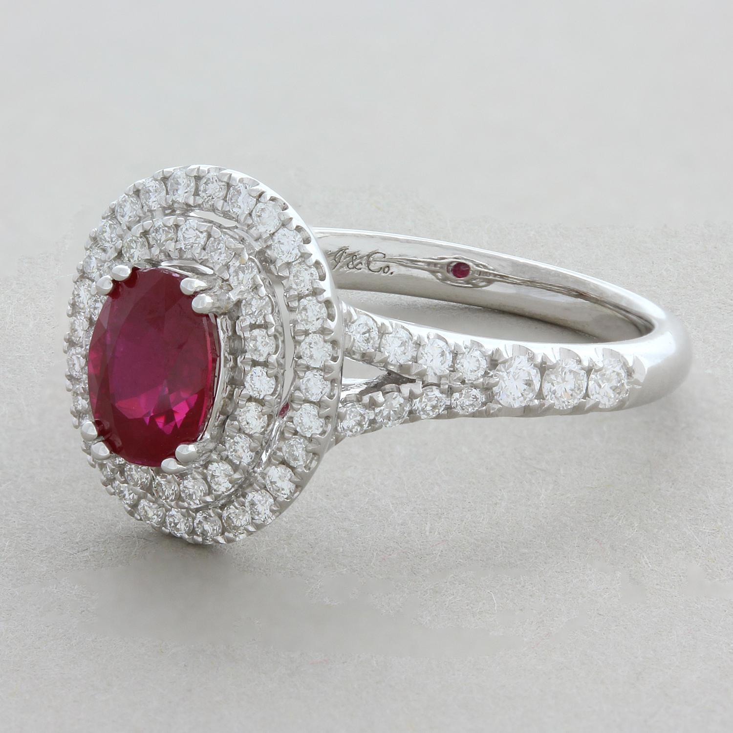 This everyday ring features a super gem 1.18 carat vivid red ruby. It is accented by a double halo of round brilliant cut diamonds with more diamonds running down the shoulders of the ring. The diamonds weight 0.59 carats and are set in a 18K white