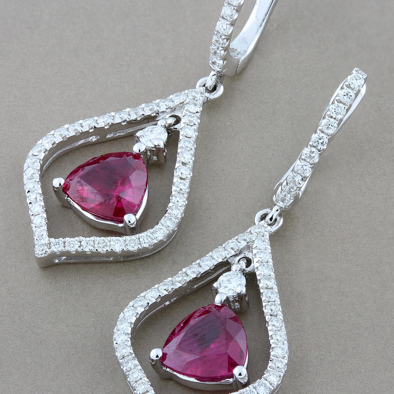 These majestic earrings feature 2.08 carats of fine round cut rubies in a silhouette of 0.70 carats of VS quality diamonds. The rubies have the perfect red color most desired by top gem collectors.  All set in 18K white gold.   

Earring Length: