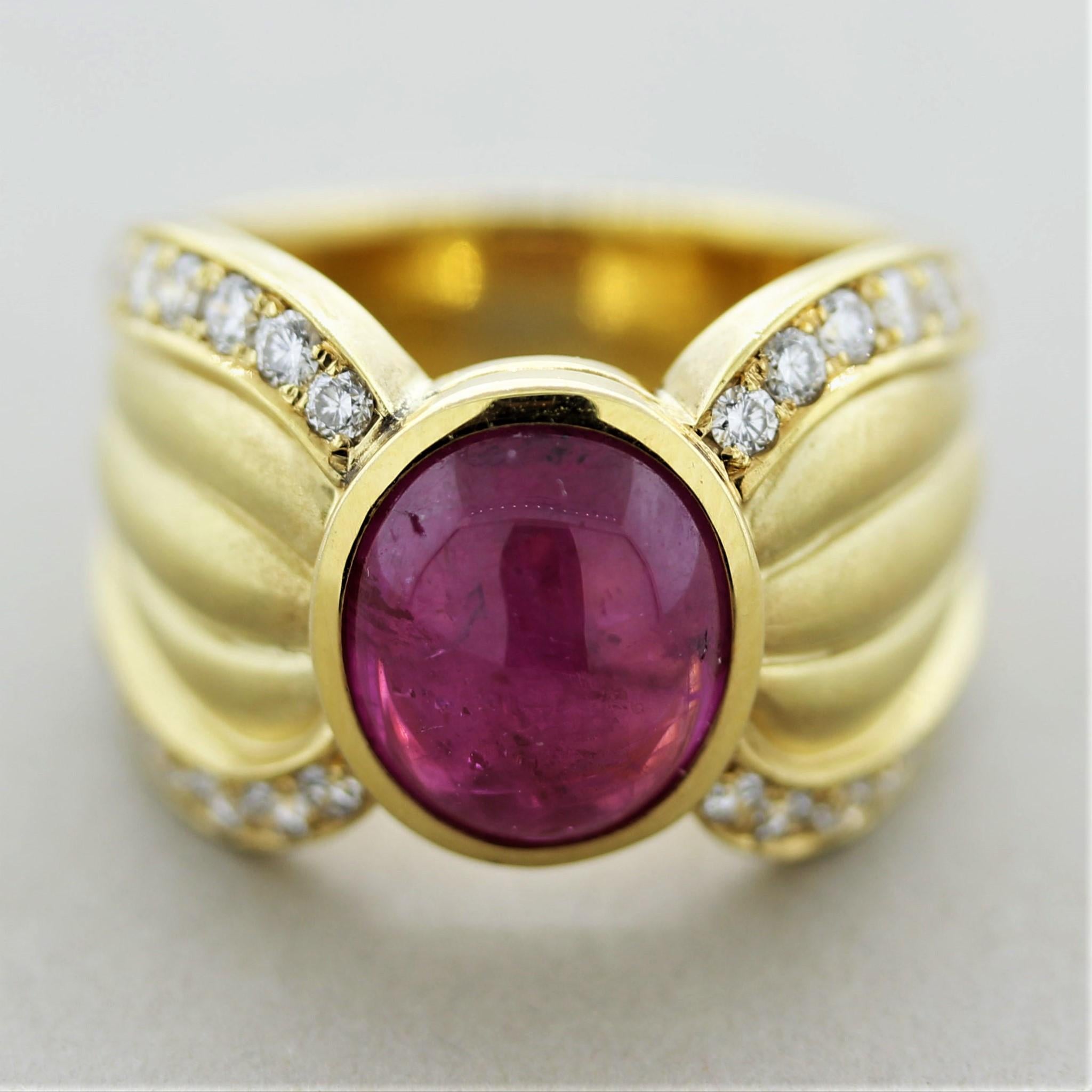 A work of art and piece of jewelry. This lovely ring features a 4.90 carat cabochon ruby with a bright and rich red color. It is accented by 0.86 carats of round brilliant-cut diamonds which are set on the borders of the ring adding sparkle and