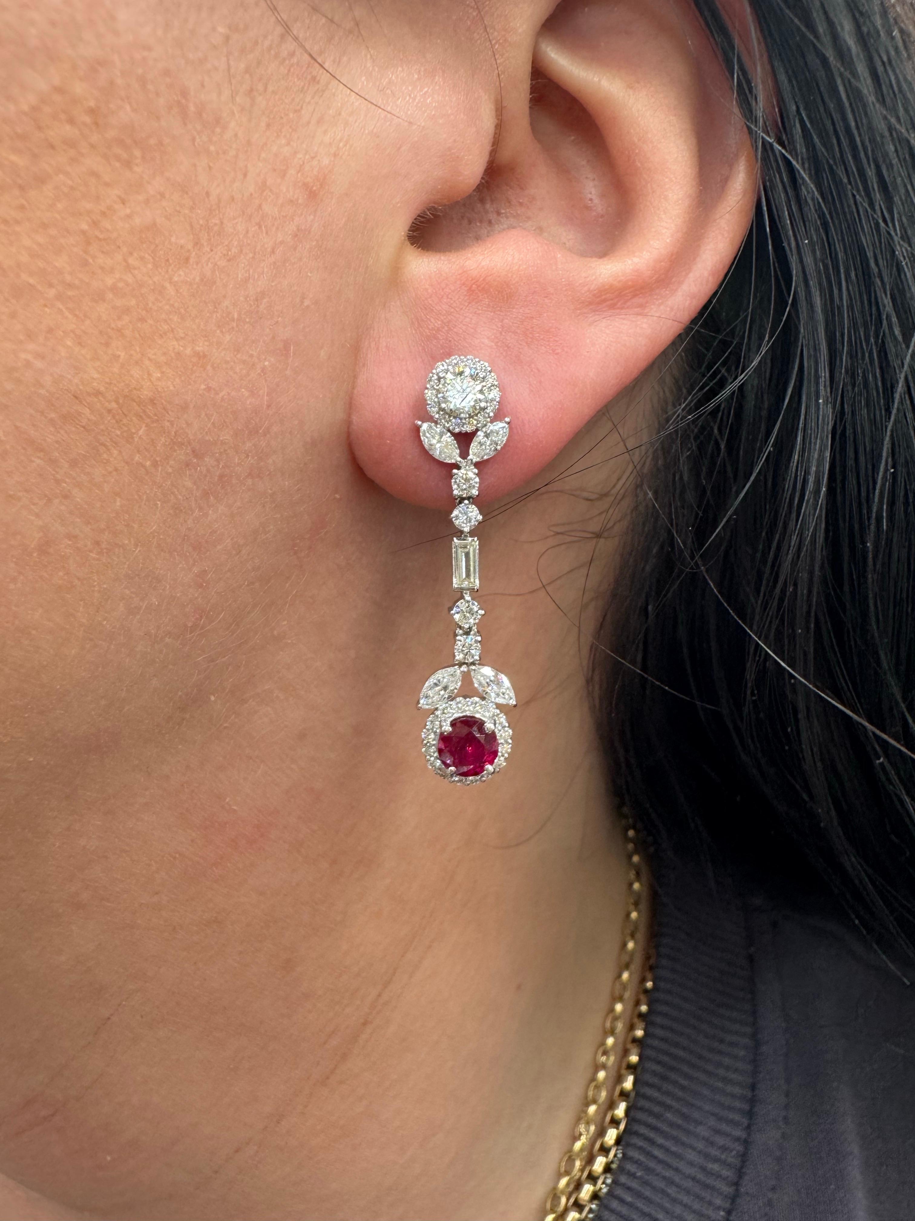 18 Karat white gold drop earrings featuring a collection of Round Brilliants, Baguettes and Marquise diamonds weighing a total of 2.29 carats with two rich color round Rubies weighing 1.28 carats.  
Diamond Quality: F VS

More Ruby Earrings &