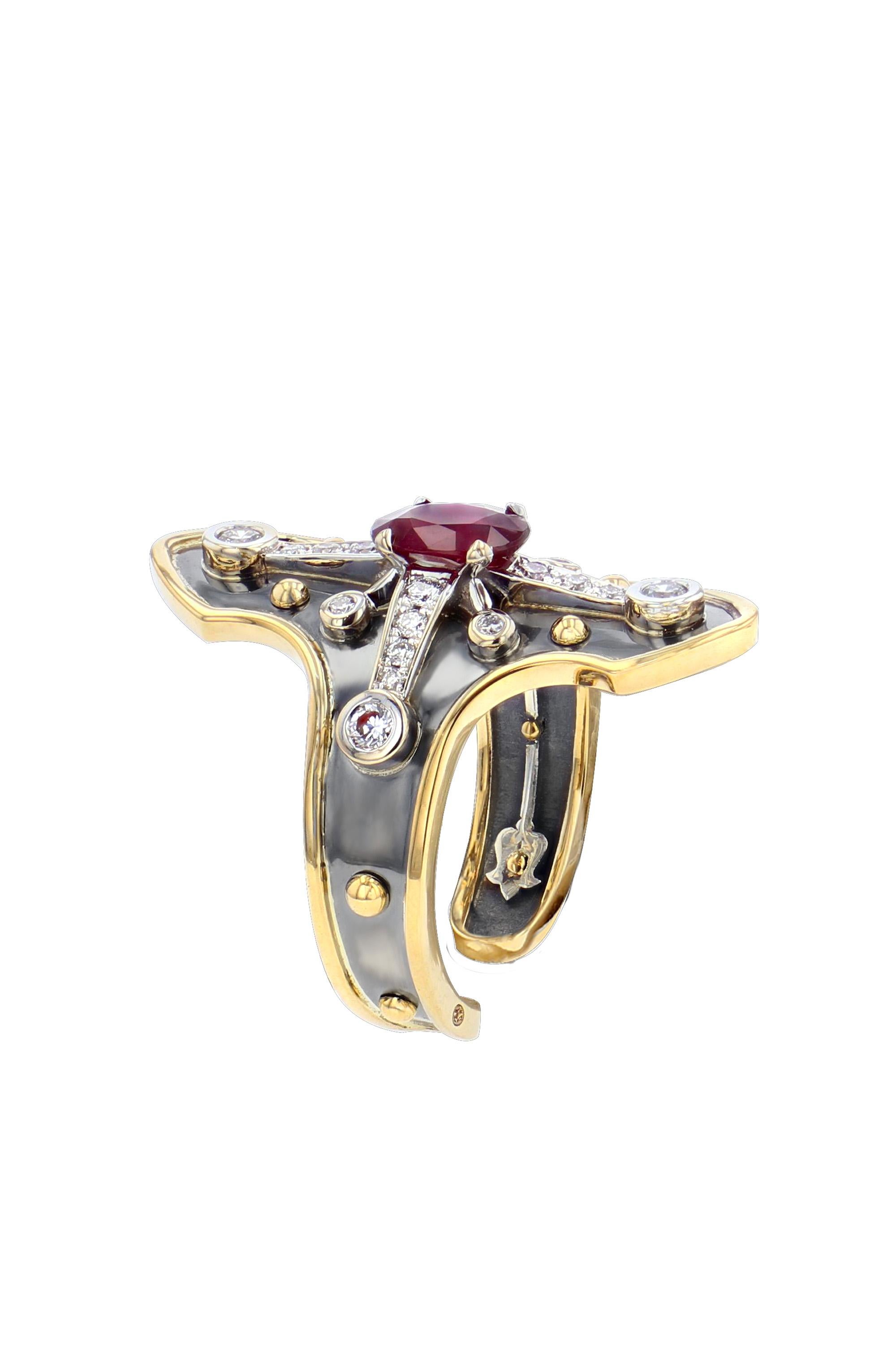 Yellow gold and distressed silver ring studded with an oval ruby surrounded by diamonds set on a white gold star.

Details:
Oval Ruby: 7x5x 1 cts
Diamonds : 0,36 cts
18k Yellow Gold : 4,5 g
Distressed Silver : 3 g
Made in France