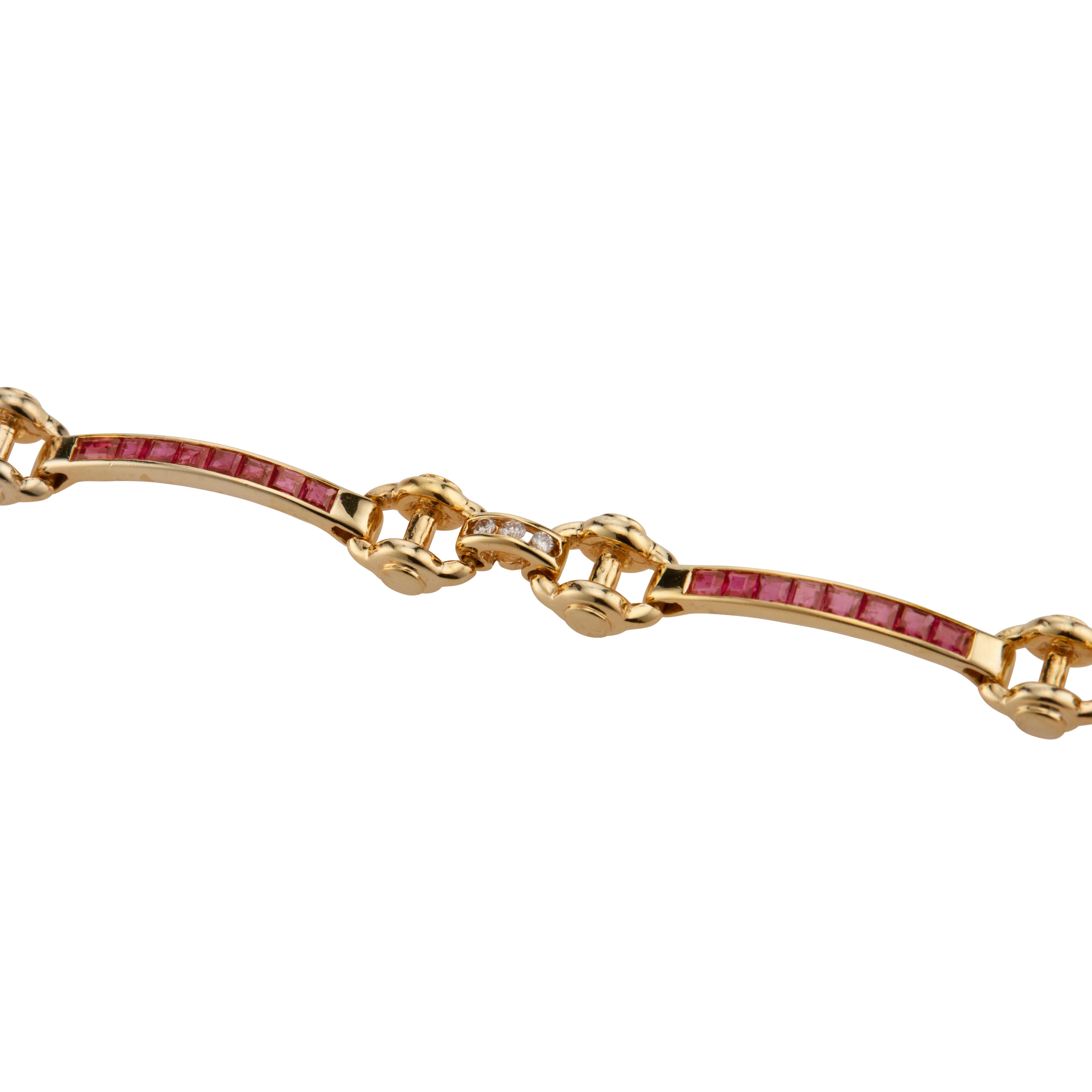 Ruby and diamond Bar, hinged link 18k yellow gold bracelet. 32 square cut rubies accented with 12 round diamonds. 6.75 inches.

32 square cut red Rubies 1.28 carat. 2mm, SI
12 round diamonds, approx. total weight .12cts
18k yellow gold
Tested and