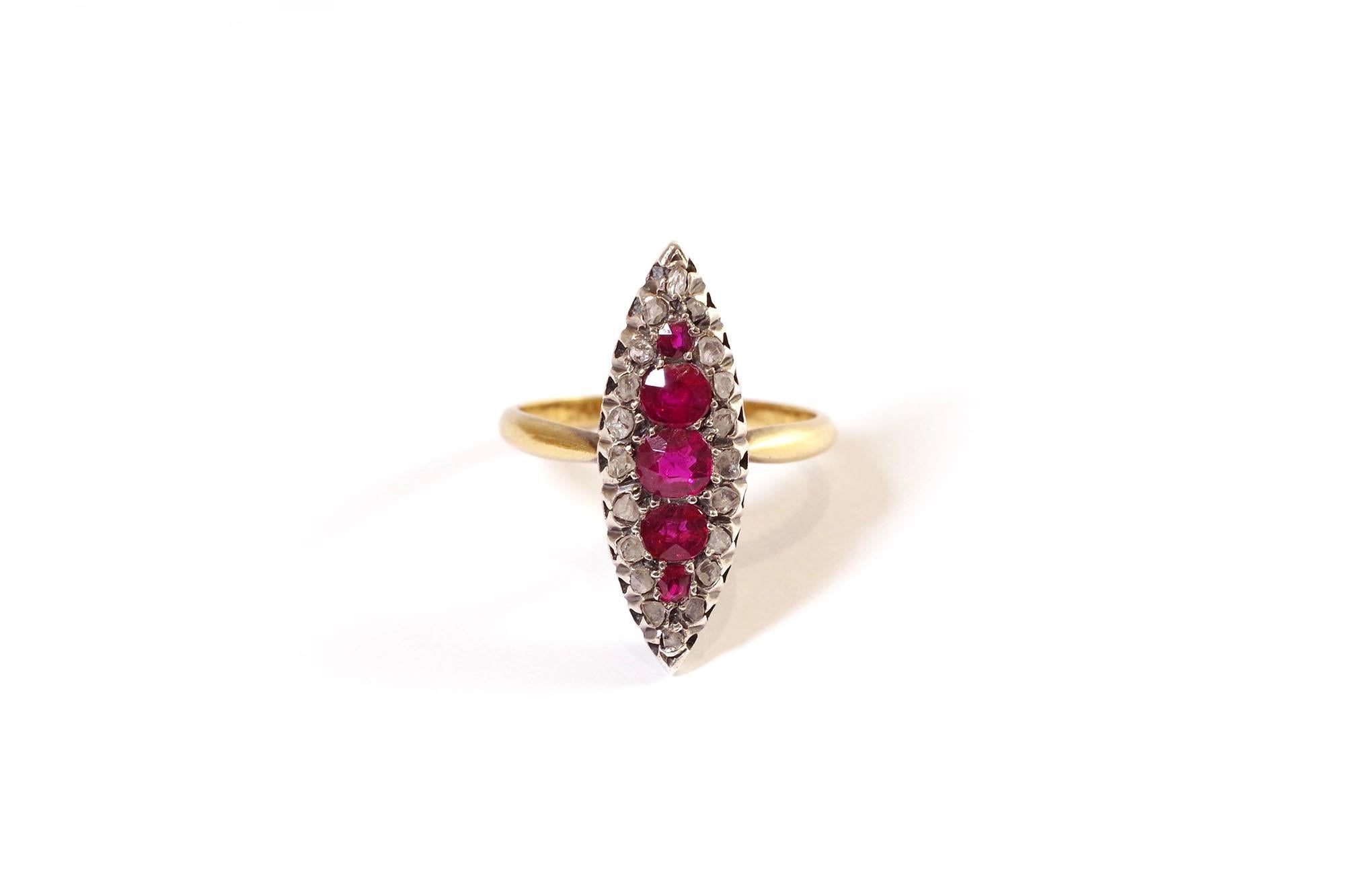 Ruby diamond marquise ring in rose gold 18 karats and silver. Antique ring centred by a line of five natural rubies of round and oval cut, the most important weighing approximately 0,38 carat. The rubies are surrounded by twenty flat rose-cut