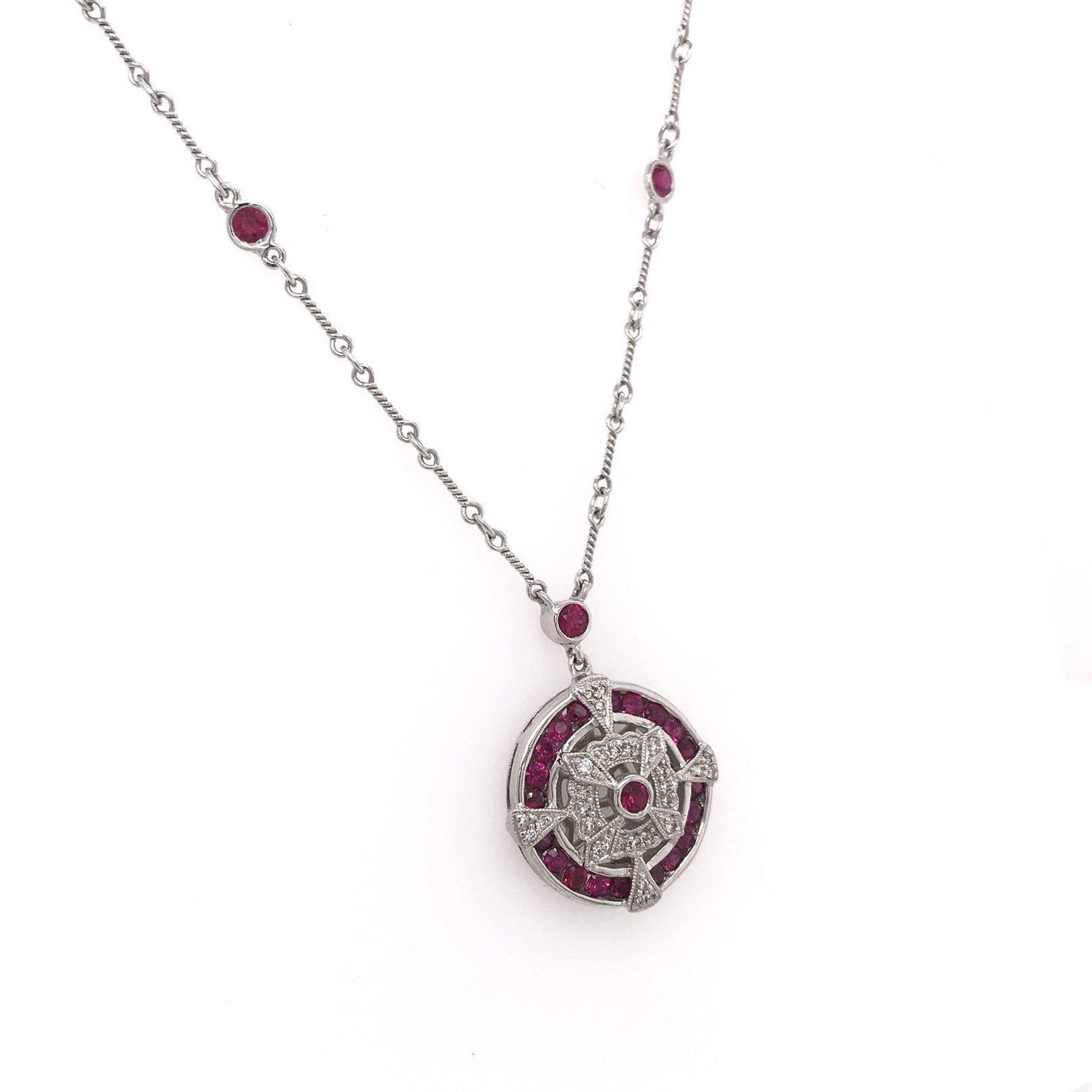 This is a contemporary piece, new and never worn. This stunning diamond and ruby necklace features 36 tiny sparkling diamond accents as well as 24 vibrant red ruby accents. The setting is 14K white gold and features contemporary filigree as well as
