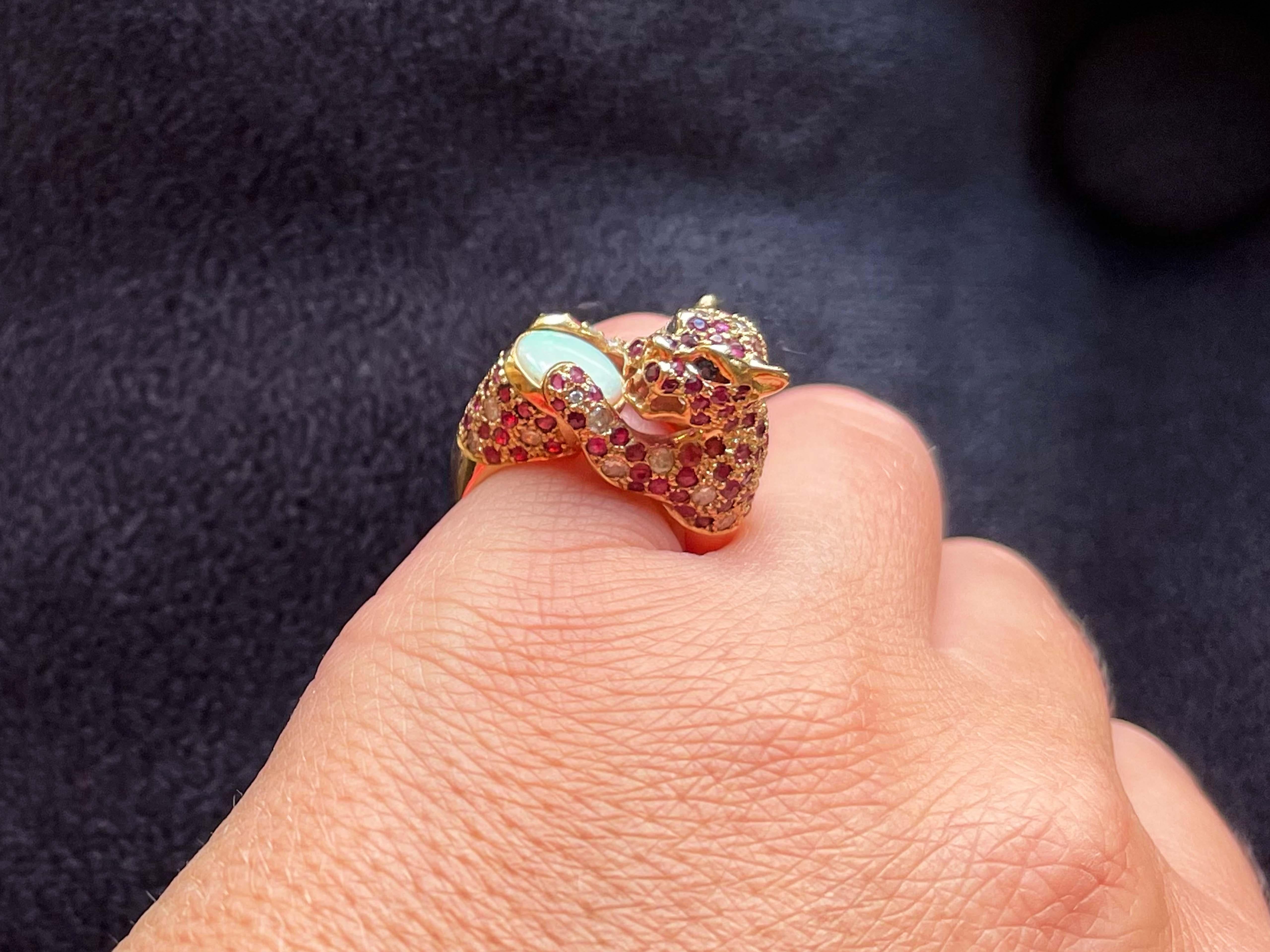 Item Specifications:

Metal: 14K Yellow Gold

Style: Statement Ring

Ring Size: 6 (resizing available for a fee)

Total Weight: 8.1 Grams
​
​Opal Carat Weight: ~1.00 carats

Ruby Carat Weight: ~1.00 carats

Diamond Carat Weight: ~0.50