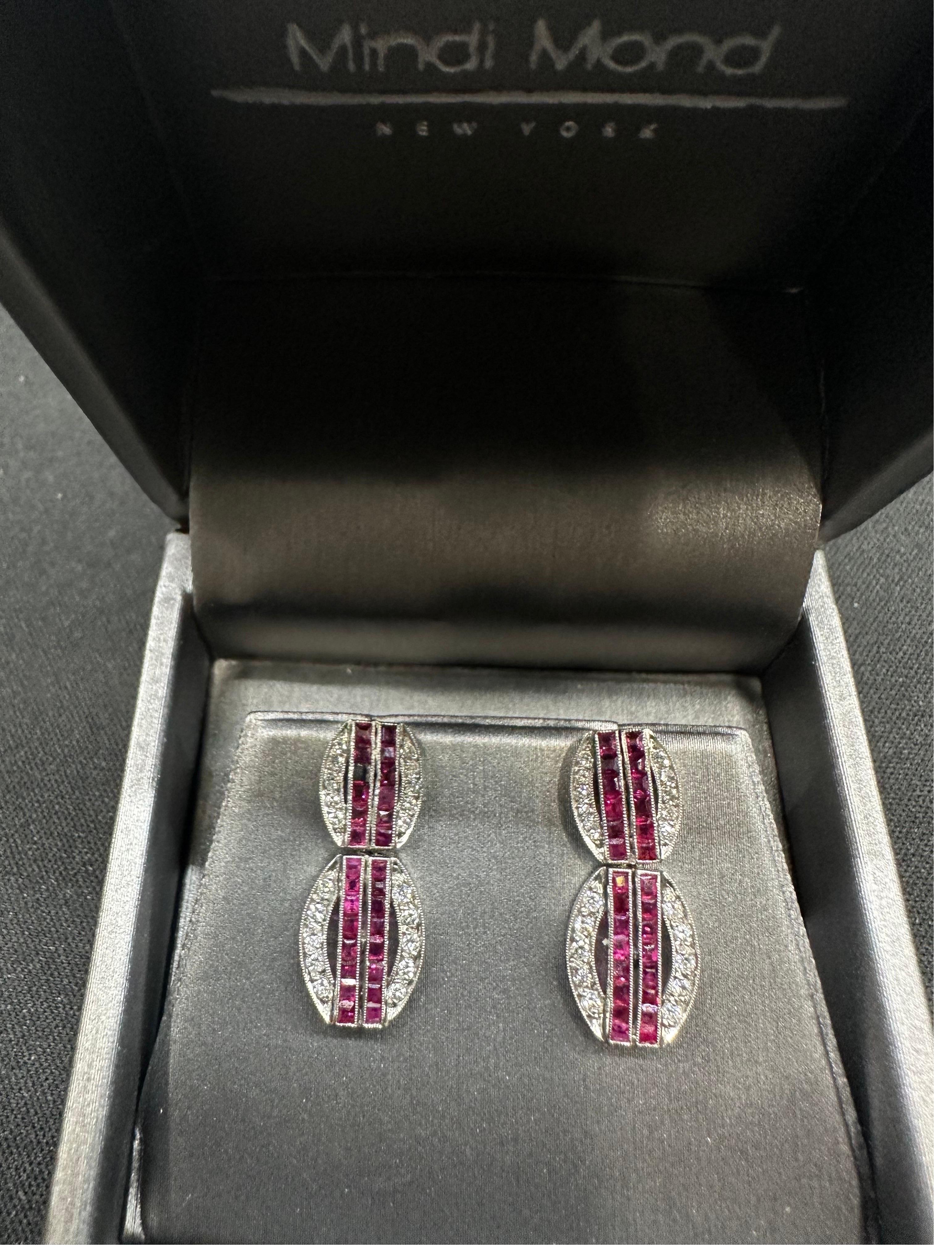 Step into the captivating world of Art Deco with our Mindi Mond Ruby Diamond Art Deco Platinum Drop Earrings. These remarkable earrings embody timeless elegance and sophistication, showcasing a design that transcends eras. With 1 carat square-cut