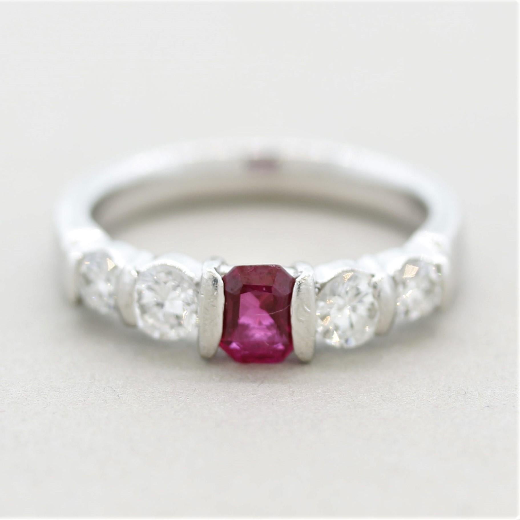 A simple set chic and stylish platinum band featuring ruby and diamonds! The ruby weighs 0.48 carats and has a bright vivid pinkish-red color. It is accented by 4 large round brilliant-cut diamonds weighing a total of 0.60 carats. Hand-fabricated in