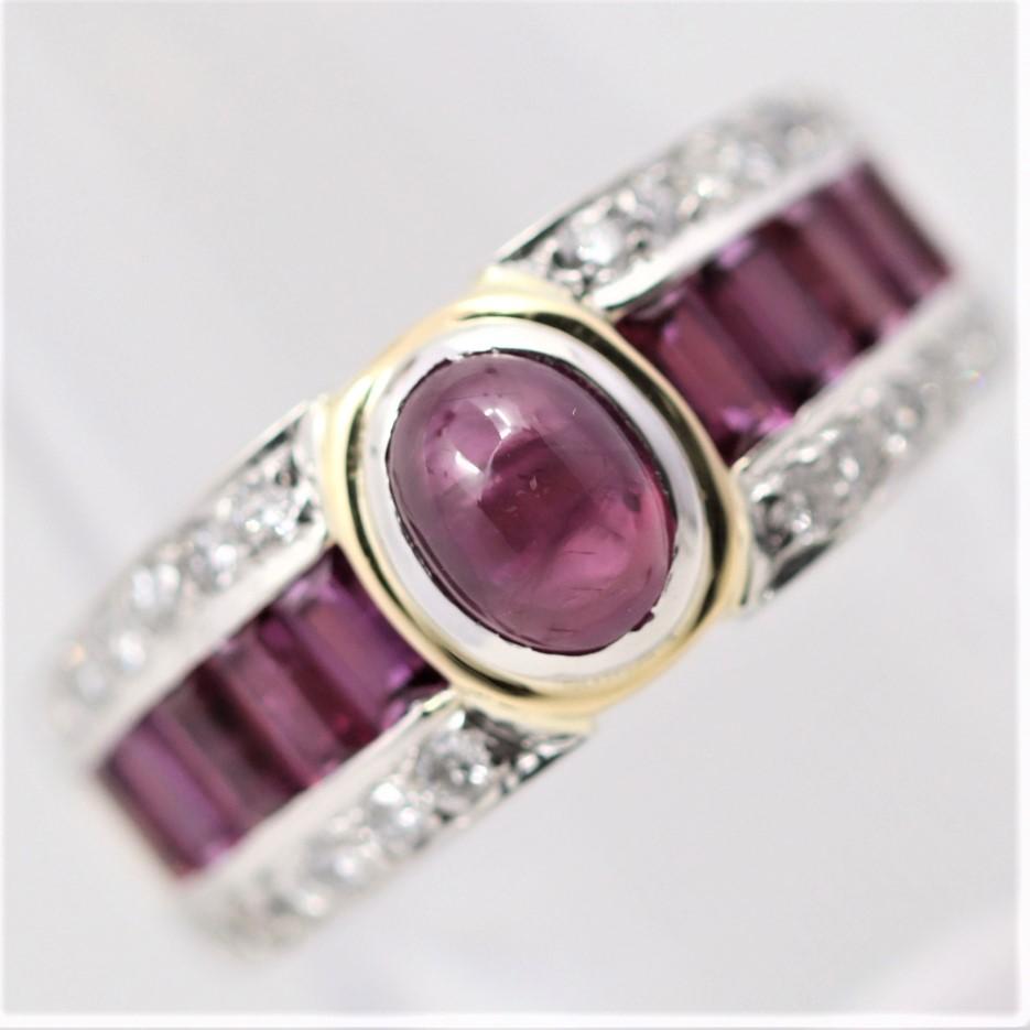 A lovely band style ring featuring a 1.39 carat cabochon ruby along with additional ruby and diamond accents. There are 1.69 carats of straight baguette-cut rubies running down the sides of the ring along with 0.43 carats of diamonds which add
