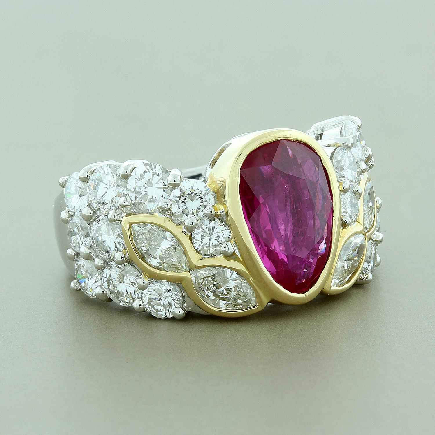 A regal 1.98 carat pear shape ruby is bezel set in the center of this elegant ring. It is accented by 2.95 carats of marquise and round brilliant cut diamonds set in 18K yellow gold over a platinum setting. A one of a kind design for a one of a kind