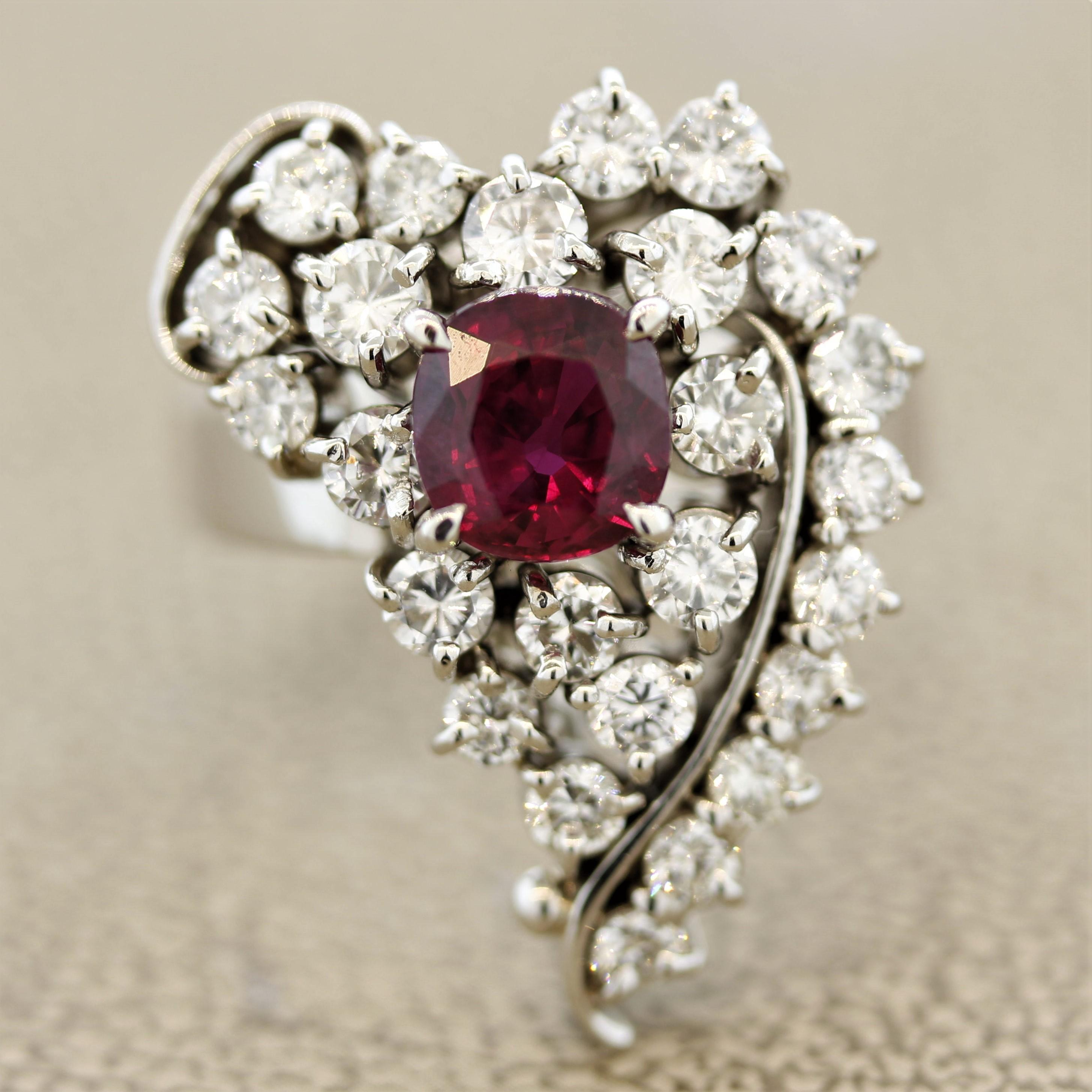 A stylish ring resembling a heart featuring fine quality gems. The cushion shaped ruby weighs 1.66 carats and has a pure vivid red color. A true gem of a ruby. It is accented by 1.73 carats of round brilliant cut diamonds which are set inside the