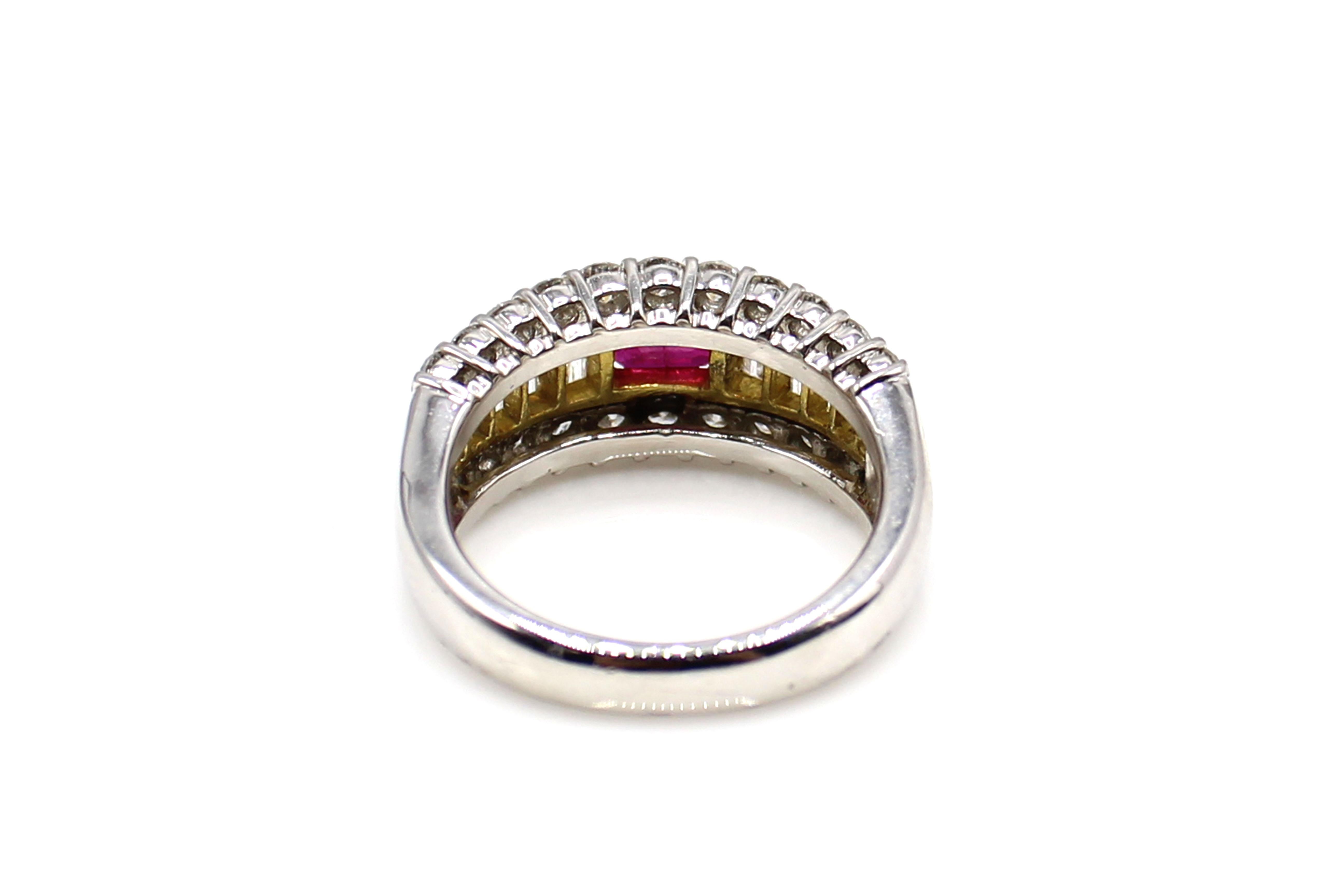 Beautifully designed and masterfully hand-crafted this ring features a centrally set square emerald cut deep red lively ruby securely held in between 2 bars of high polished 18 karat yellow gold. The ruby is embellished by 22 bright white and