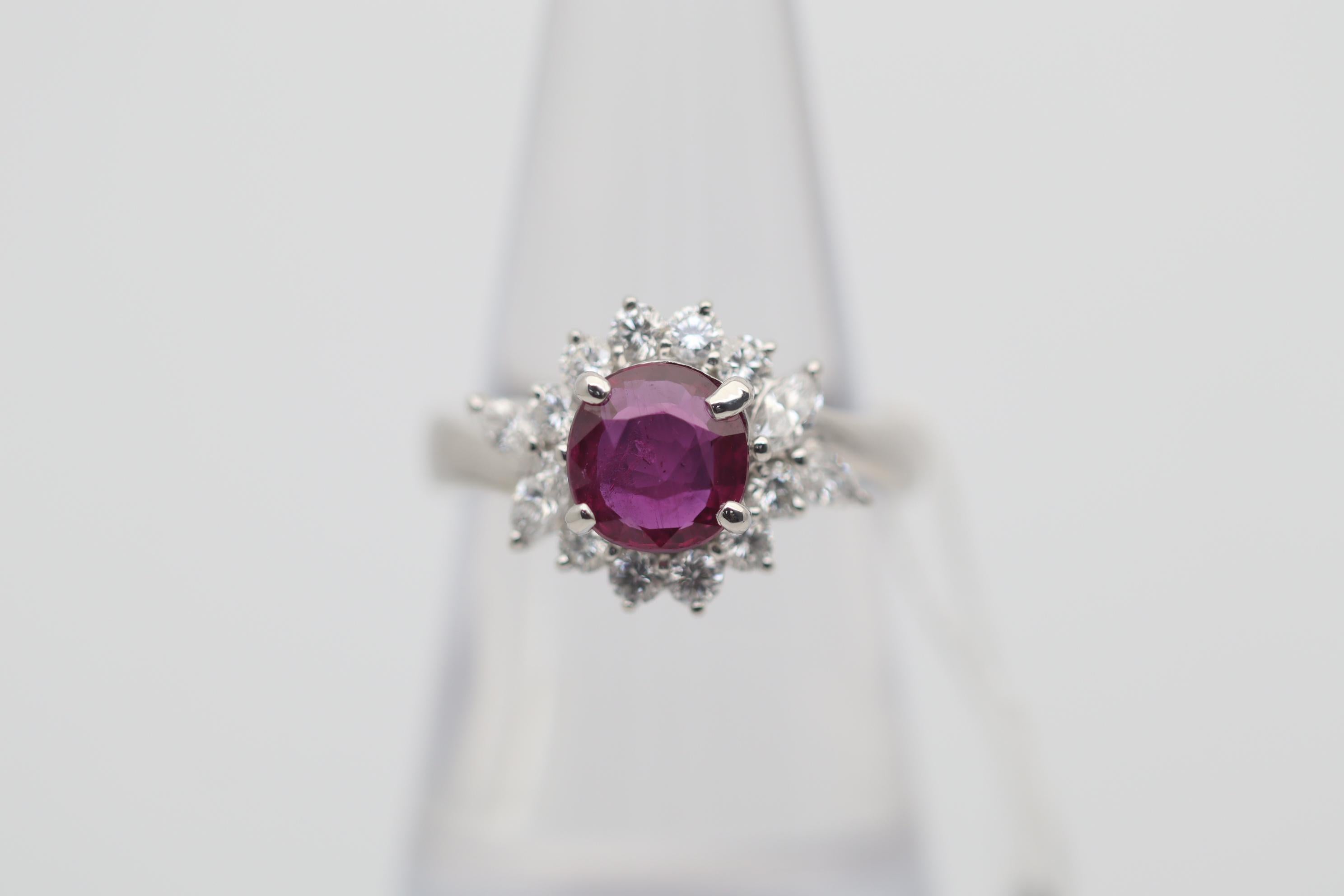 An elegant and stylish ring featuring a fine ruby weighing 1.54 carats. It is cushion-shaped and has a rich red color and a brilliant crystal. It is accented by 0.67 carats of round brilliant and marquise-shape diamonds set around the ruby in a