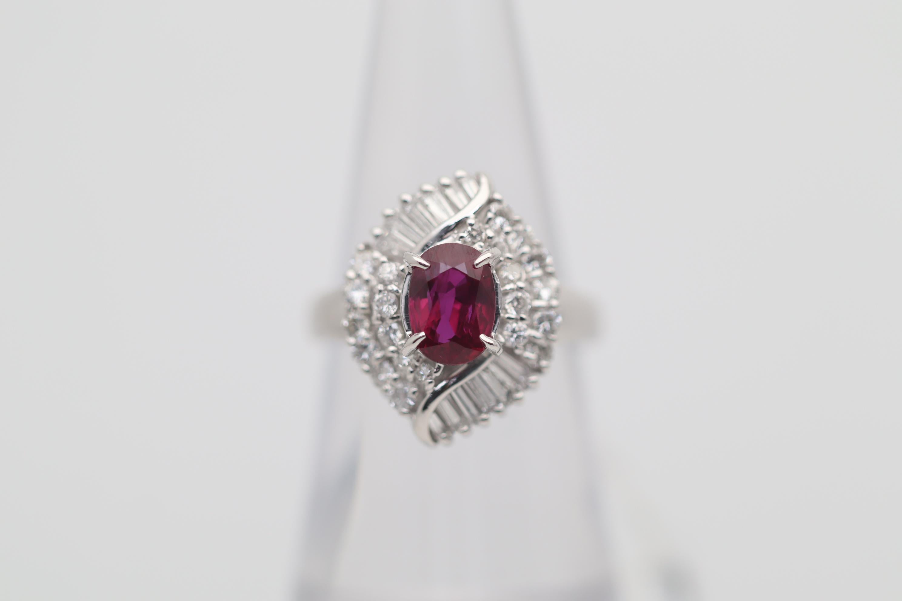 A sweet and fine platinum ring featuring a 1.43 carat ruby with a rich gem vivid red color. It has a lovely oval-shape that is just so pleasing to gaze into. It is complemented by 0.78 carats of round brilliant and baguette-cut diamonds set around