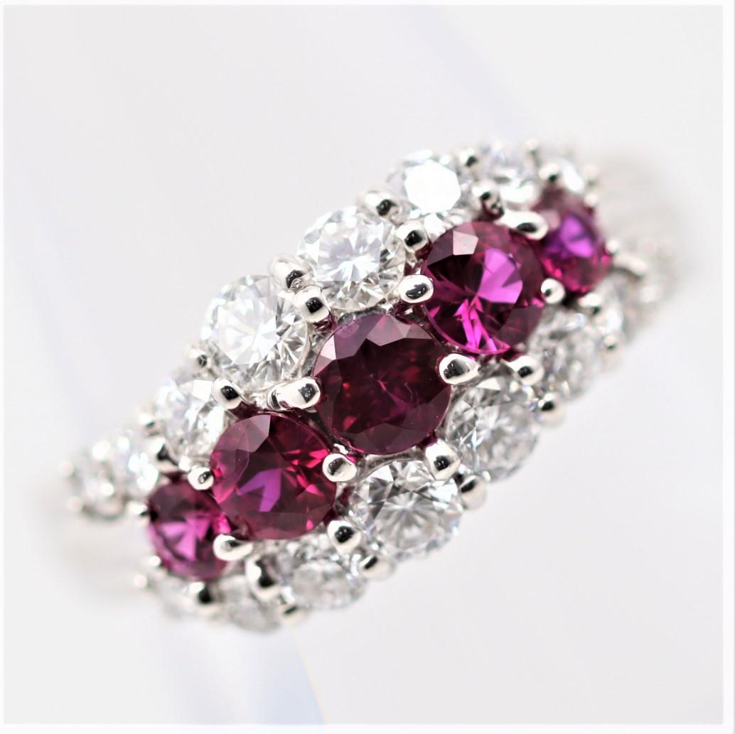 A lovely platinum band featuring superb gem-quality pigeon blood rubies. There are a total of 6 rubies which weigh 1.04 carats together and have an intense vivid red color. They are accented by two rows of round brilliant-cut diamonds set above and