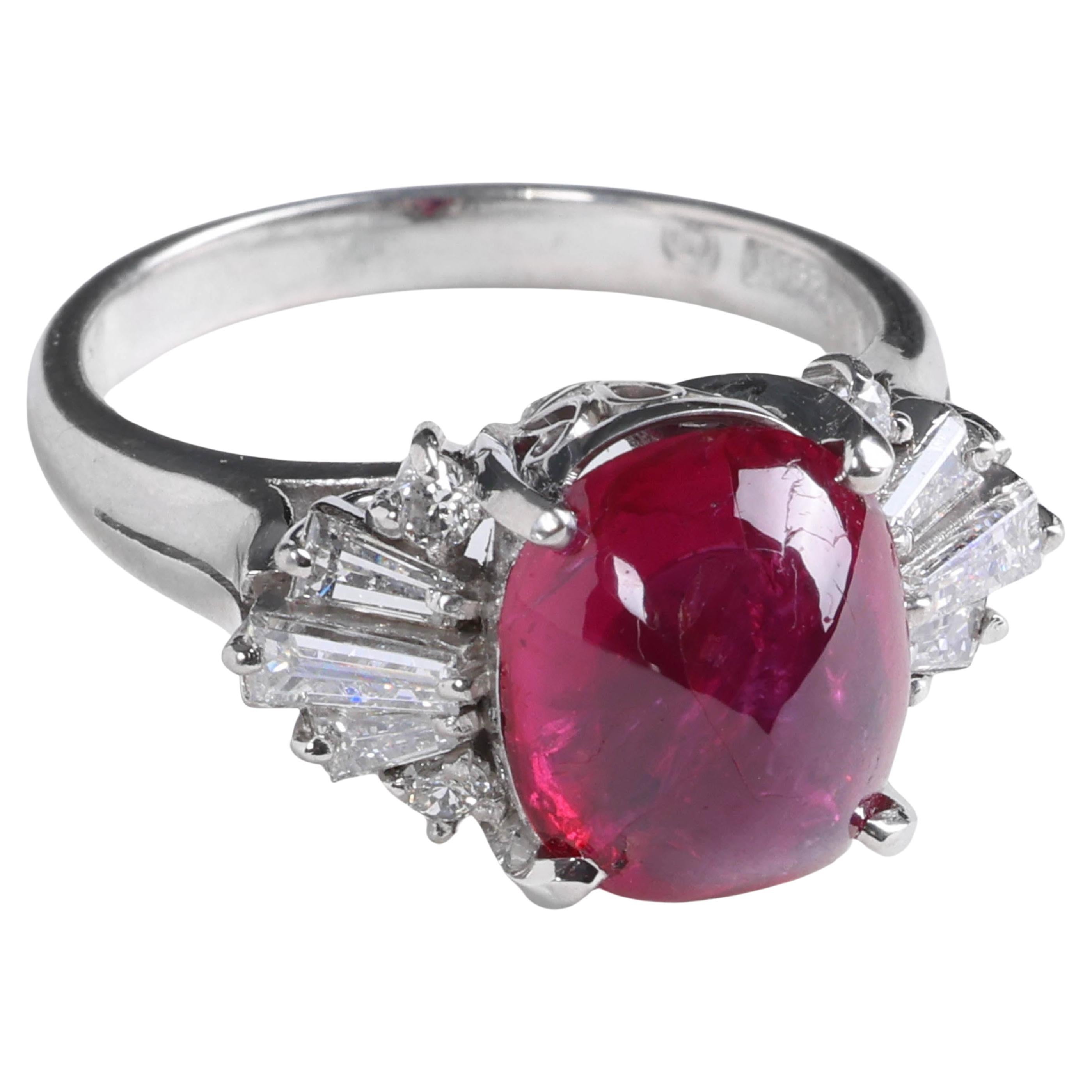 An enormous, spectacular four-carat cabochon-cut vivid pinkish-red no-heat Burma ruby commands attention in this extraordinary platinum Mid-century ring. The stoplight-red ruby measures 10.33mm x 8.74mm x 4.84mm and weighs 4.75 carats. Three sleek