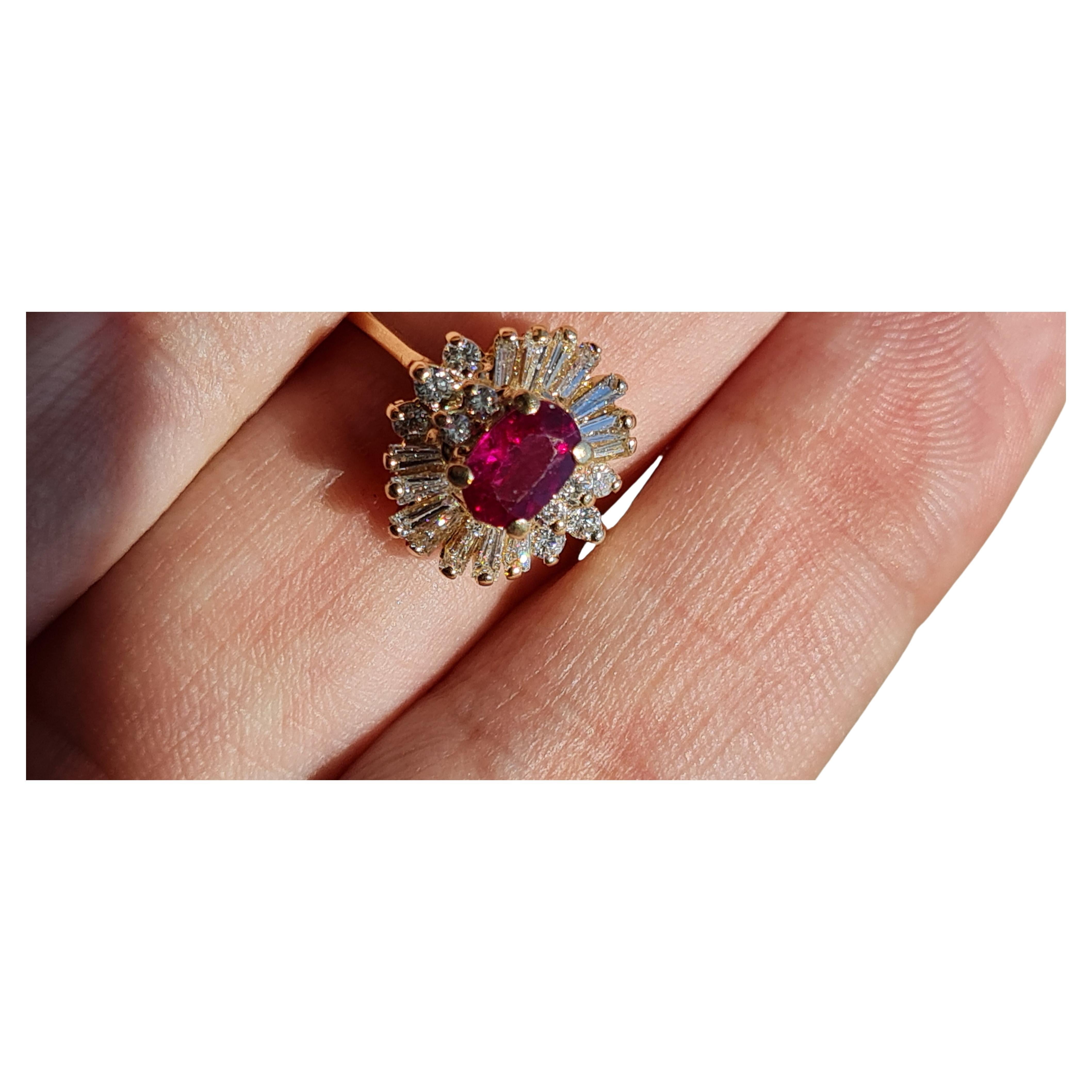 Offered is a 14K Yellow Gold Ruby and Diamond Ballerina Ring by Exquisite.  The ring features a 6x4mm oval shape 1/2ct Ruby.  The Ballerina setting is accented with Ten Round Diamonds and Fourteen Tapered Baguette Diamonds adding 1/2tdw ~ GIA