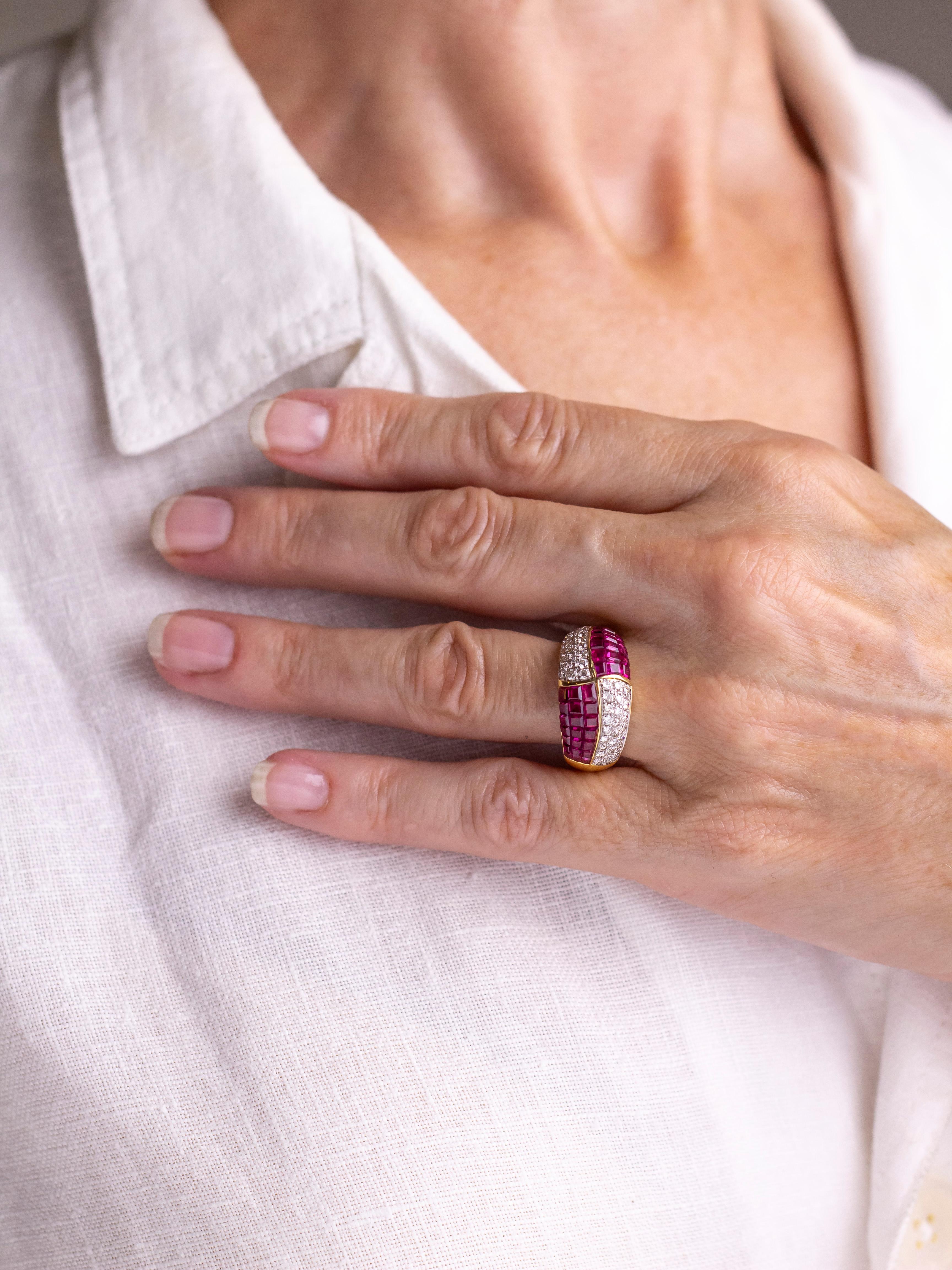 Crafted from 18 karat yellow gold and set with rubies and diamonds, this ring was manufactured by the North American firm Hammerman Brothers. The bombe style ring features two panels of diamonds and two panels of 'mystery' set red rubies. Each of