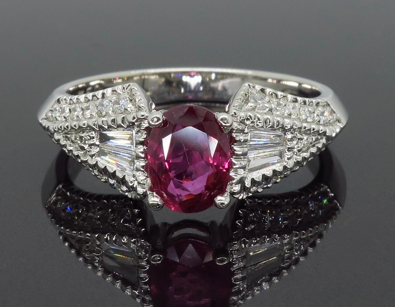 Vintage inspired Ruby and Diamond ring crafted in 18k white gold.

Gemstone: Ruby & Diamond
Gemstone Carat Weight: Oval Cut Approximately 6.36 x 4.72mm
Diamond Carat Weight: Approximately .36CTW 
Diamond Cut: Round Brilliant Cut and Tapered Baguette