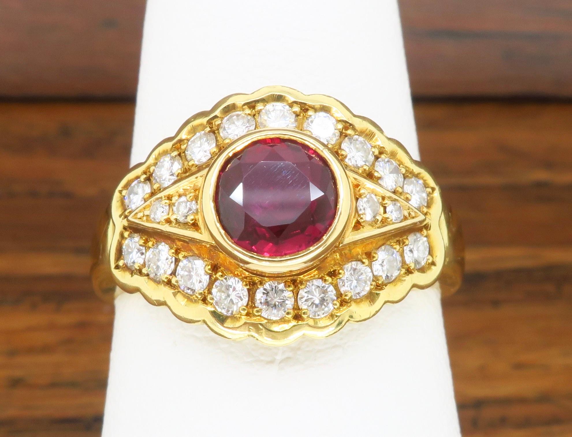 18k Yellow Gold ring mounted with a .78ct Round Ruby, flanked by .39ctw of white diamonds. 

Gemstone: Diamond and Ruby
Gemstone Carat Weight: .78ct Round Ruby
Diamond Carat Weight: .39ctw
Diamond Cut: Round Brilliant Cut  
Metal: 18k Yellow Gold