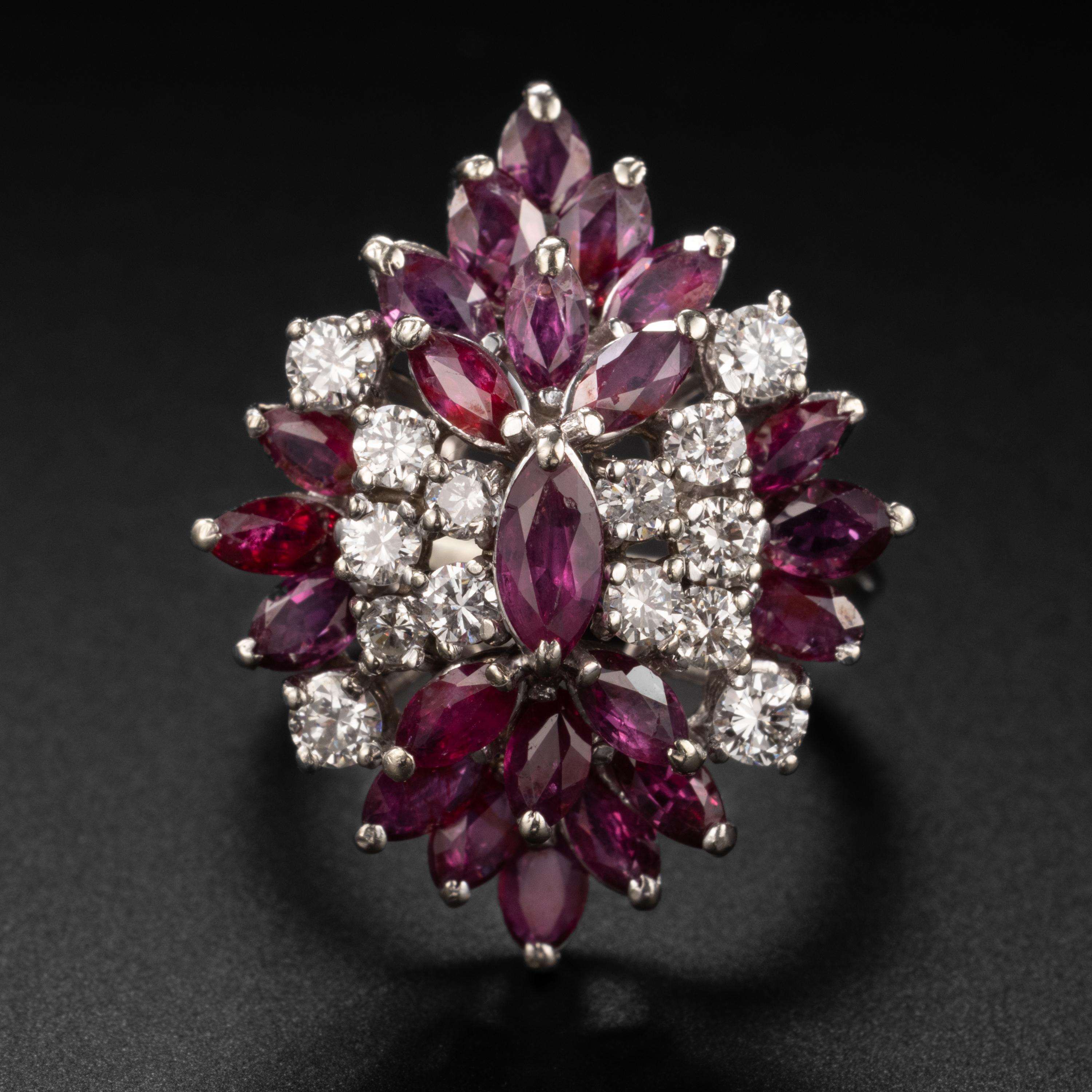 Perfectly, outrageously flashy, and fun, this Midcentury (circa 1950s) cocktail ring is bursting with marquise-cut rubies and round brilliant diamonds. There are 3.30 carats of rubies and 1.08 carats of bright white diamonds for a total carat weight