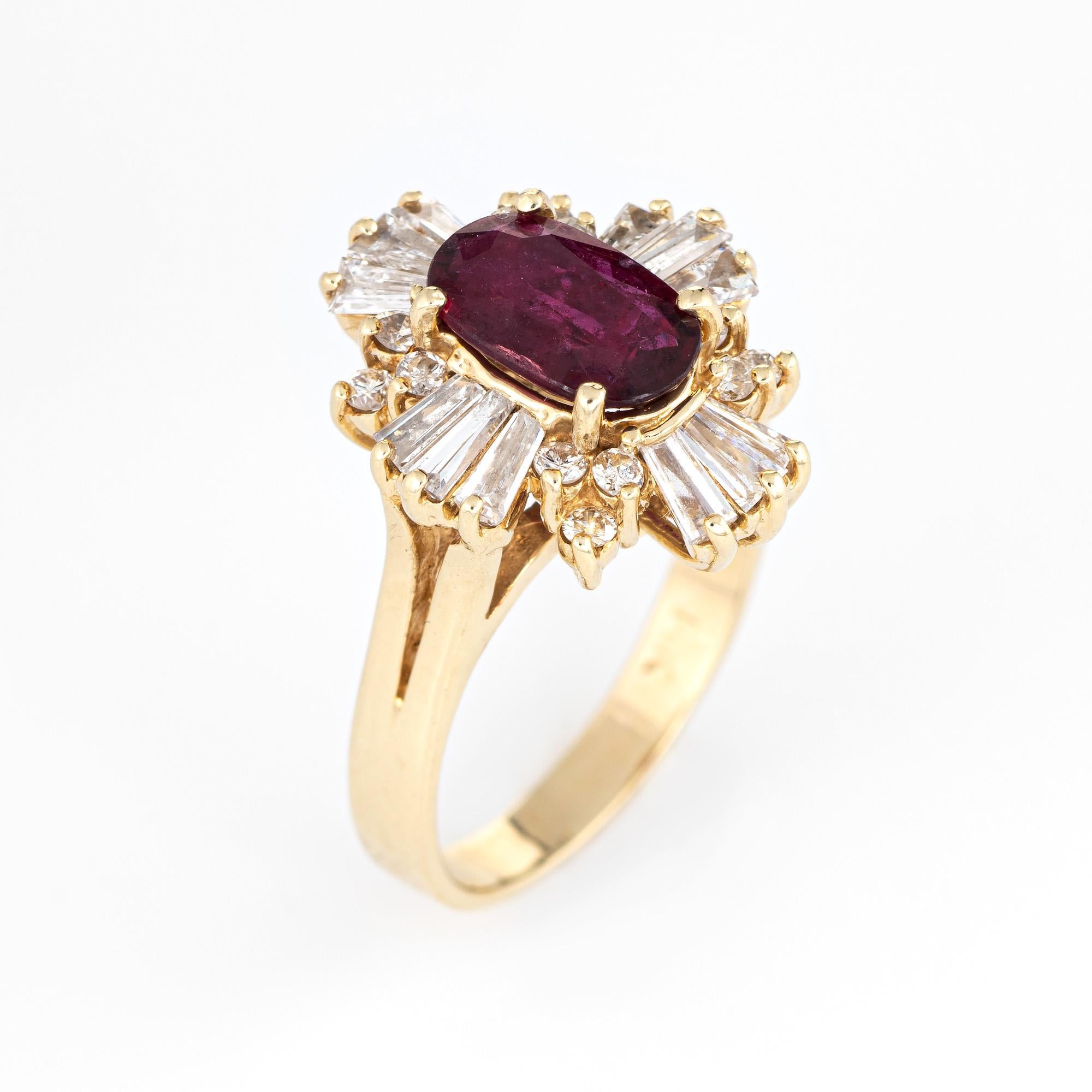 Stylish vintage ruby & diamond cocktail ring (circa 1980s) crafted in 14 karat yellow gold. 

Faceted oval cut ruby measures 9mm x 5.5mm (estimated at 1.25 carats), accented with an estimated 1.44 carats of round brilliant and baguette cut diamonds.