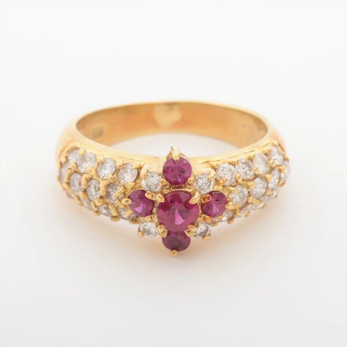The Ruby Diamond Ring in Yellow Gold is a radiant celebration of color and brilliance. At its heart lies a captivating center ruby, known for its deep red hue and timeless allure. Flanking the central stone are four smaller rubies, adding richness