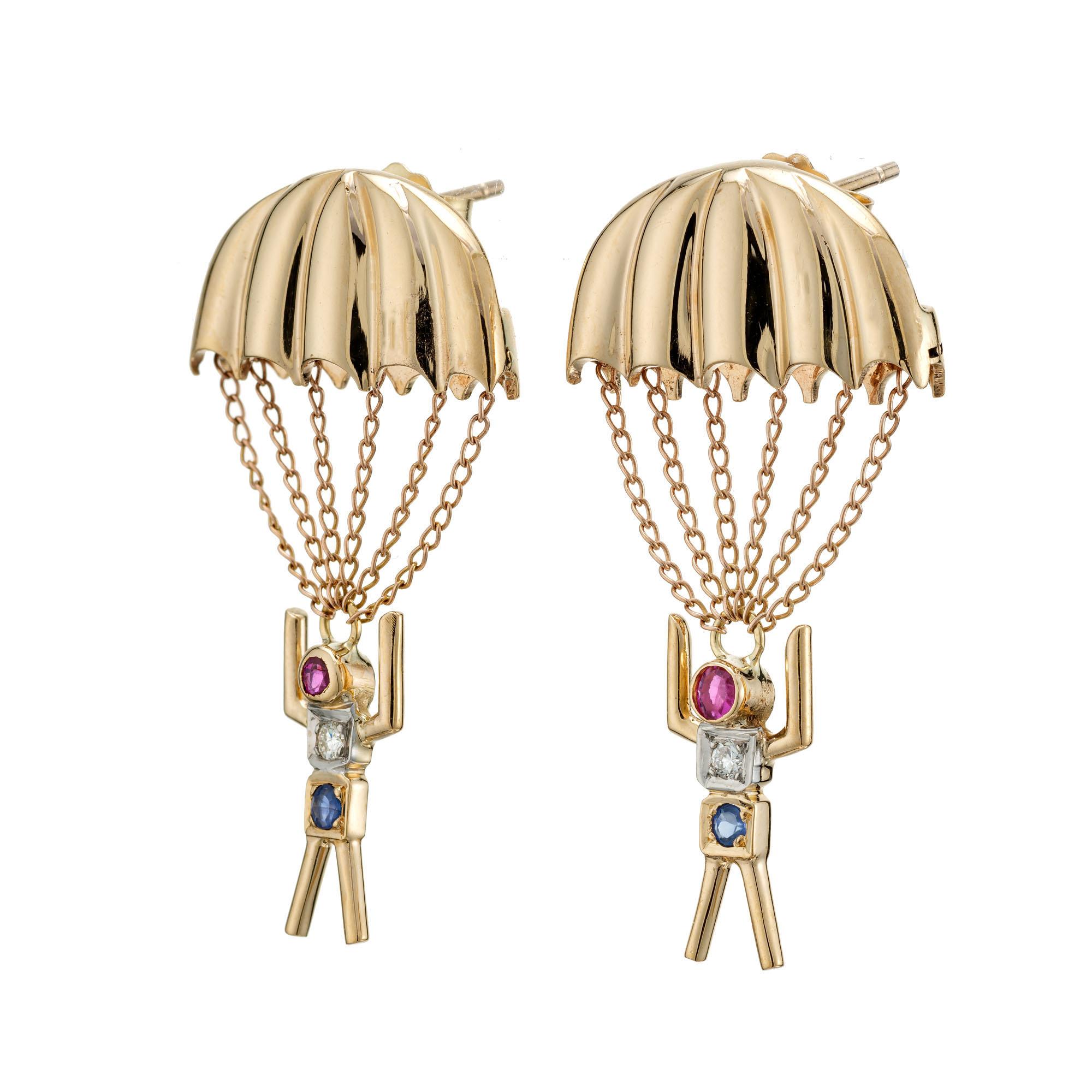 1950's Ruby, diamond and sapphire 14k yellow gold Parachute dangle earrings, with 12, 14k rose chains. 

2 round red rubies, approx. .8cts
2 round diamonds, H VS approx. .4cts
2 round blue sapphires, approx. .6cts
14k yellow gold 
Tested: 14k
5.2