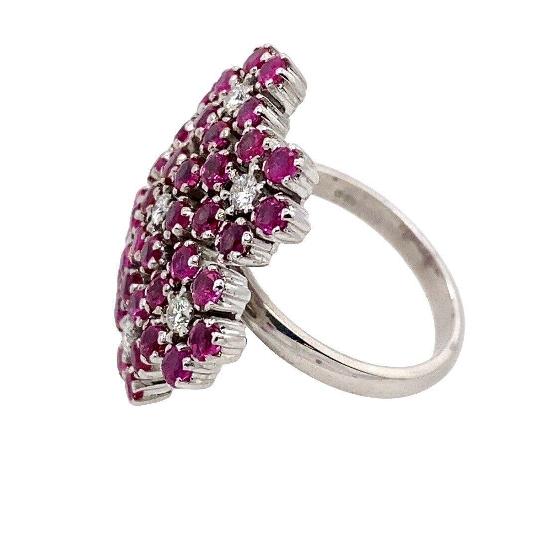 18ct White Gold Ruby & Diamond Snowflake Pattern Ring, Set With 7 Round Diamonds & 42 Rubies
42 fine quality rubies mounted on 2.5mm court shape band ring

Additional Information:
Total Diamond Weight: 0.20ct
Diamond Colour: F
Diamond Clarity: