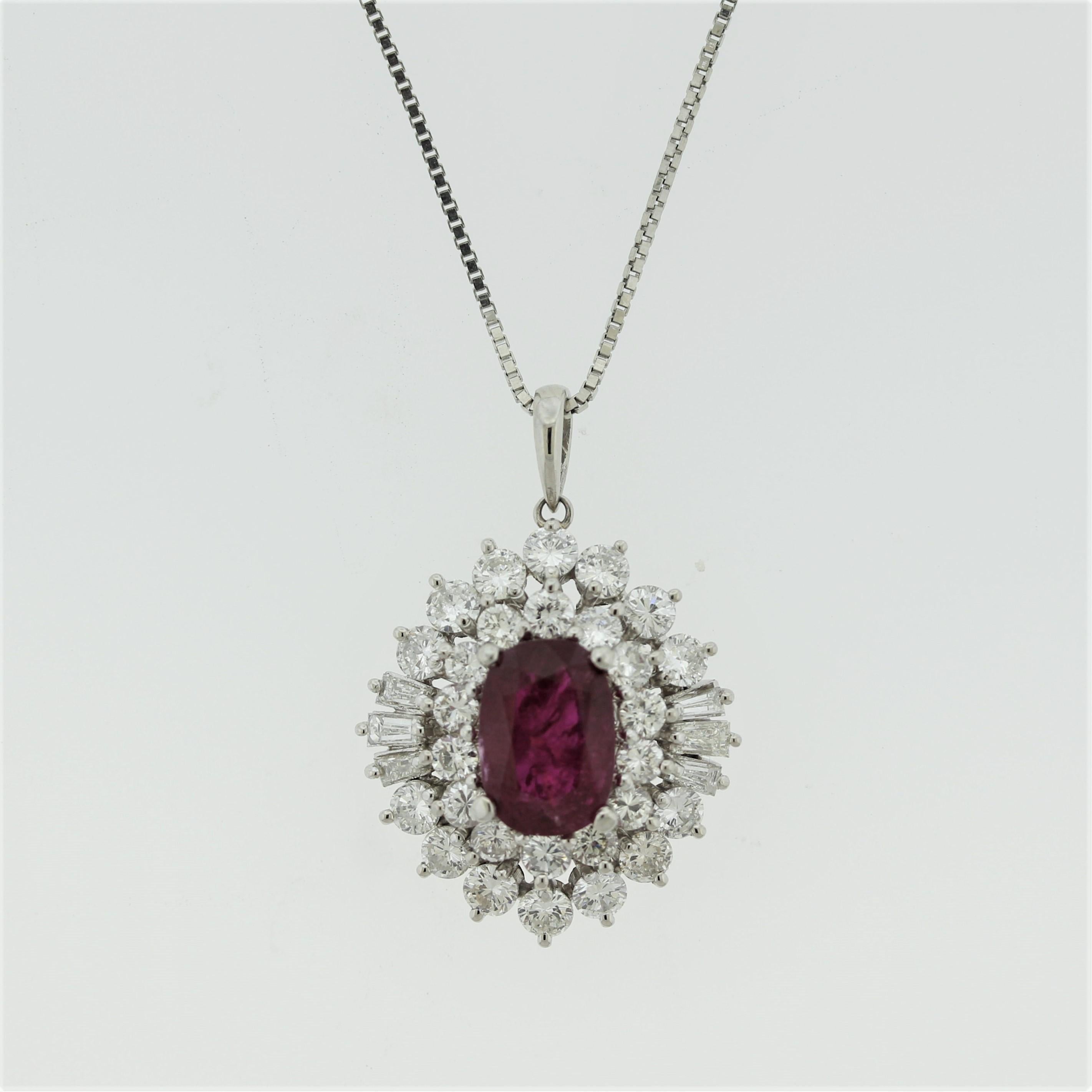 A dazzling pendant featuring a large 3.12 carat oval-shape ruby which has a rich intense red color. It is accented by a spray of large round brilliant-cut and baguette-cut diamonds creating a sunburst design around the ruby. The diamonds are of top