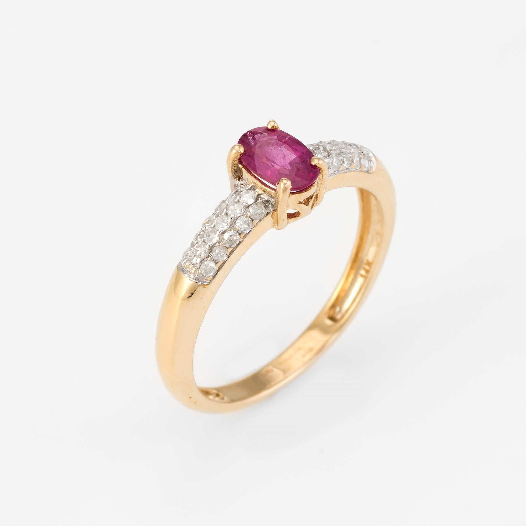 Elegant vintage stacking ring, crafted in 14 karat yellow gold. 

Faceted oval cut ruby measures 5.75mm x 4mm (estimated at 0.40 carats), accented with an estimated 0.15 carts of diamonds (estimated at H color and SI2-I1 clarity). The ruby is in