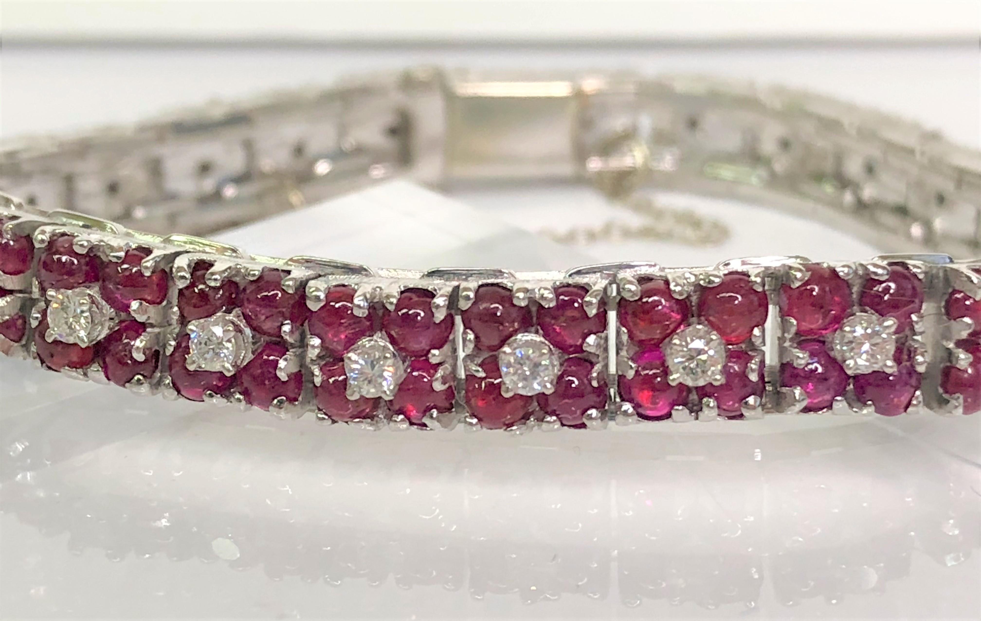 This one-of-a-kind bracelet is sure to be anyone's favorite!
27 sections, each containing one diamond surrounded by 4 cabochon rubies.  
108 rubies, each approximately 3mm round.
27 round prong set diamonds, approximately 1.9 total diamond
