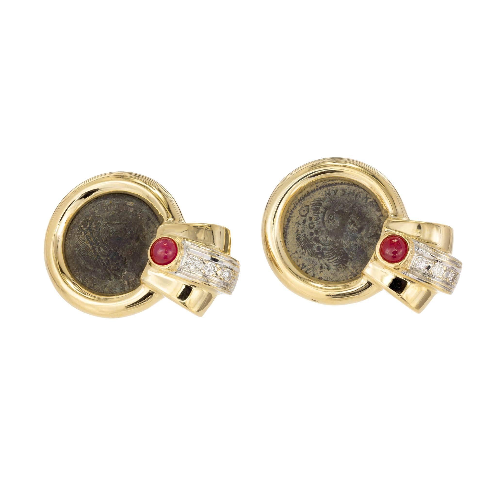 14k yellow gold coin dangle earrings with rubies and diamonds. Roman coin is bezel set in a wide yellow gold bezel with a stepped flare bottom set with a cabochon ruby and round brilliant cut diamond.

2 round cabochon rubies 4mm Approximate .50
