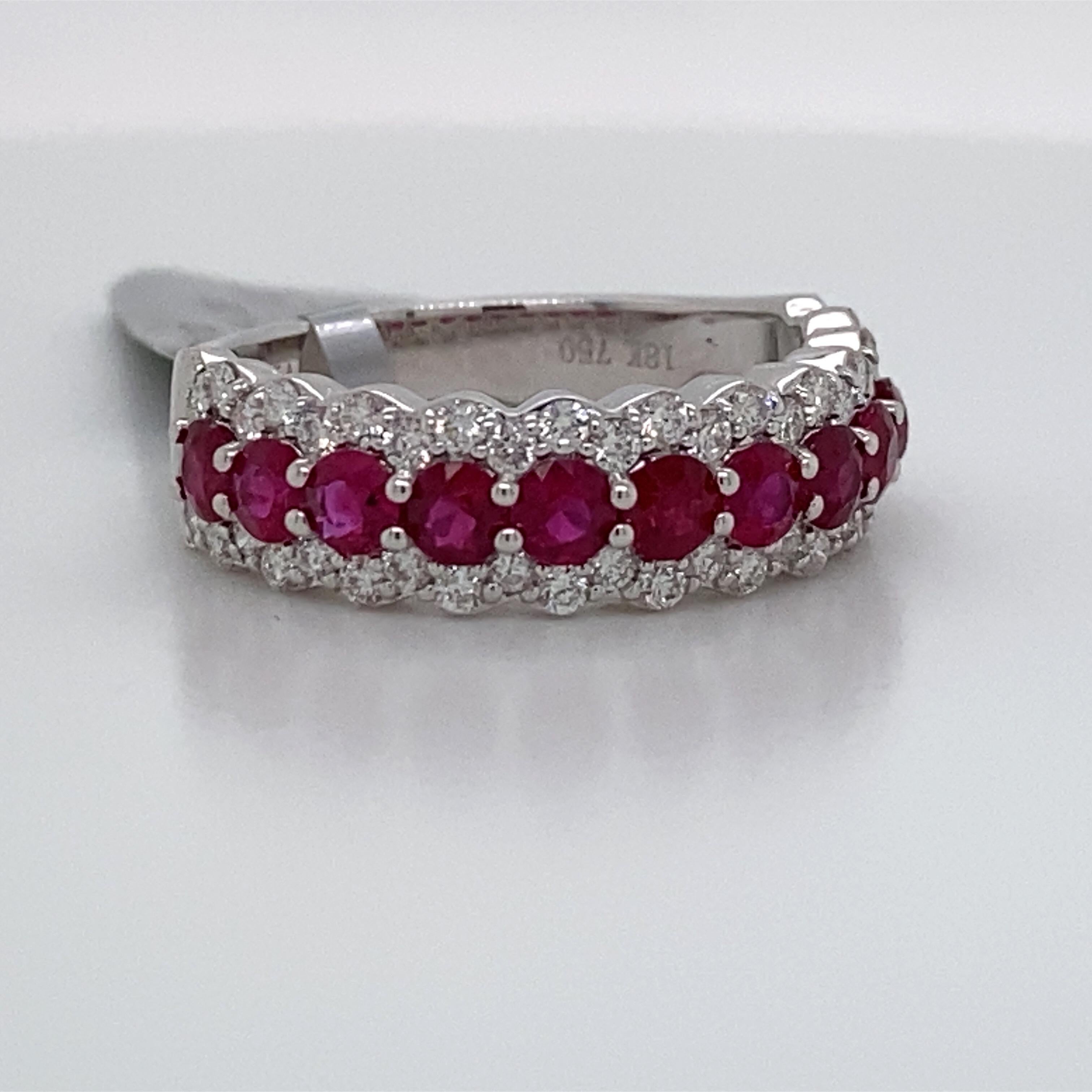 18K White gold band featuring 11 red rubies weighing 1.10 carats surrounded by 50 round brilliants weighing 0.60 carats.
Great for stacking! 
Color G-H
Clarity SI