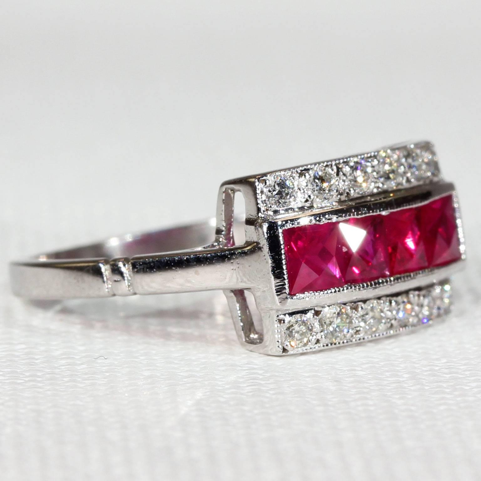 This vintage ruby and diamond ring was handcrafted around 1980 in 18 karat white gold. The ring features a row of four square cut deep pink rubies between two rows of diamonds, each row consisting of 6 transitional cut round stones. The rubies total