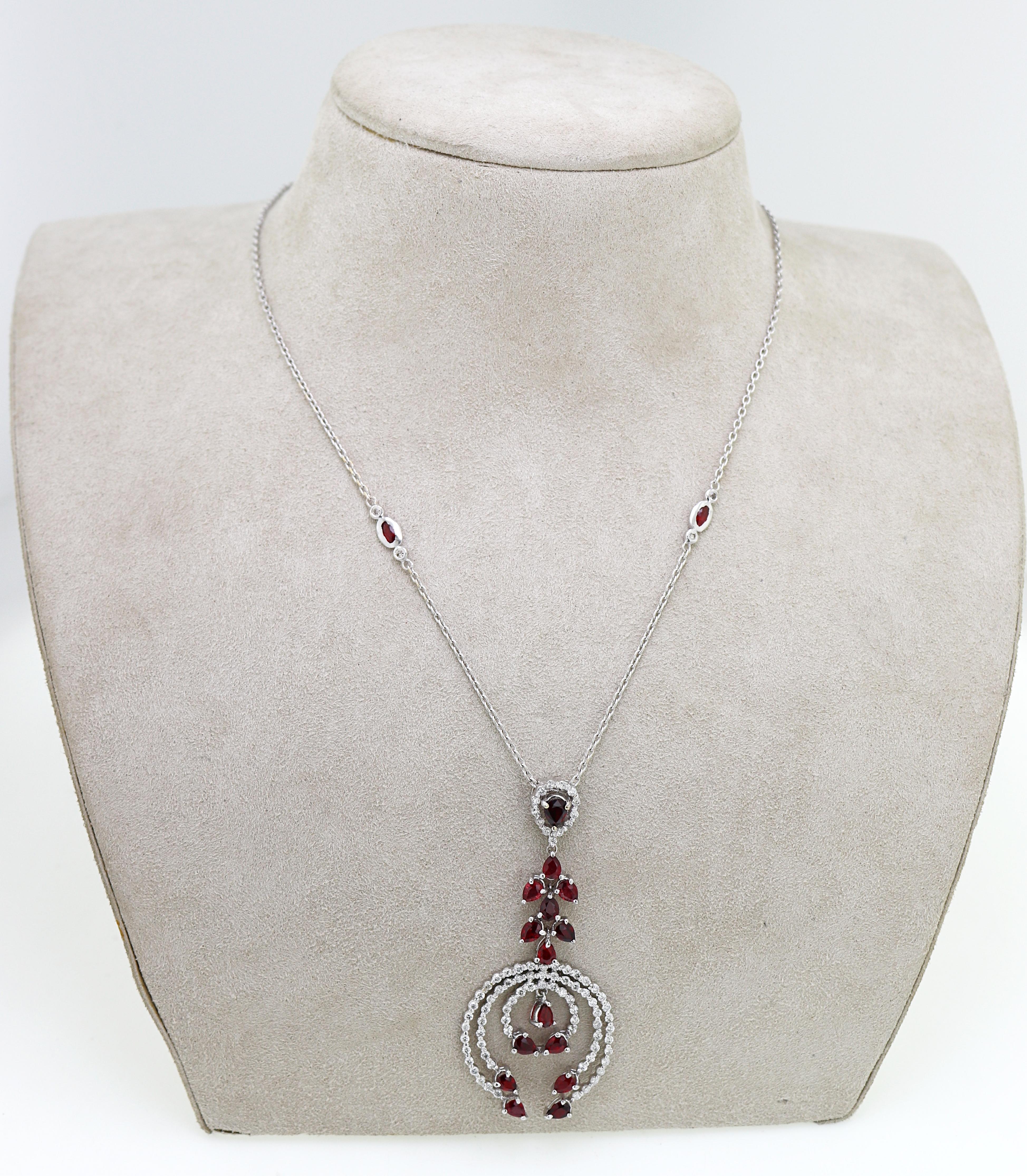 Featuring (4) marquise and (15) pear-cut vivid red rubies, 3.60 cts. tw.,
accented by (68) full-cut diamonds, 1.50 cts. tw., SI-I, I-J, prong set in an
18k white gold articulated “triple naja” style drop pendant, 58.9 X 25 X 3.6
mm, suspending from