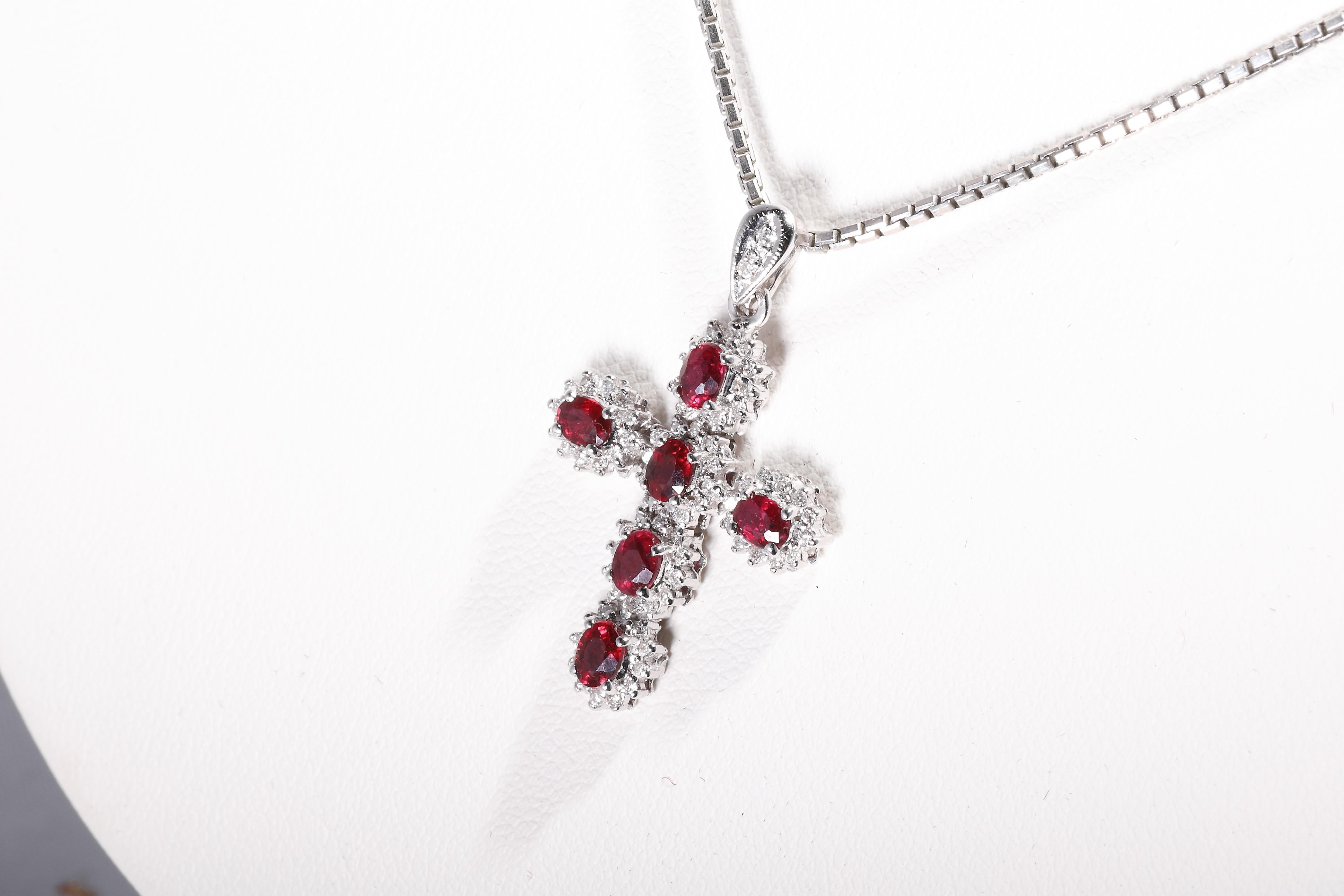 18 k white gold 
hallmarked with fineness 750
6 ruby together 1,27 ct
diamonds together 0,27 ct
Size: 30 x 20 mm
weight: 3 grams
