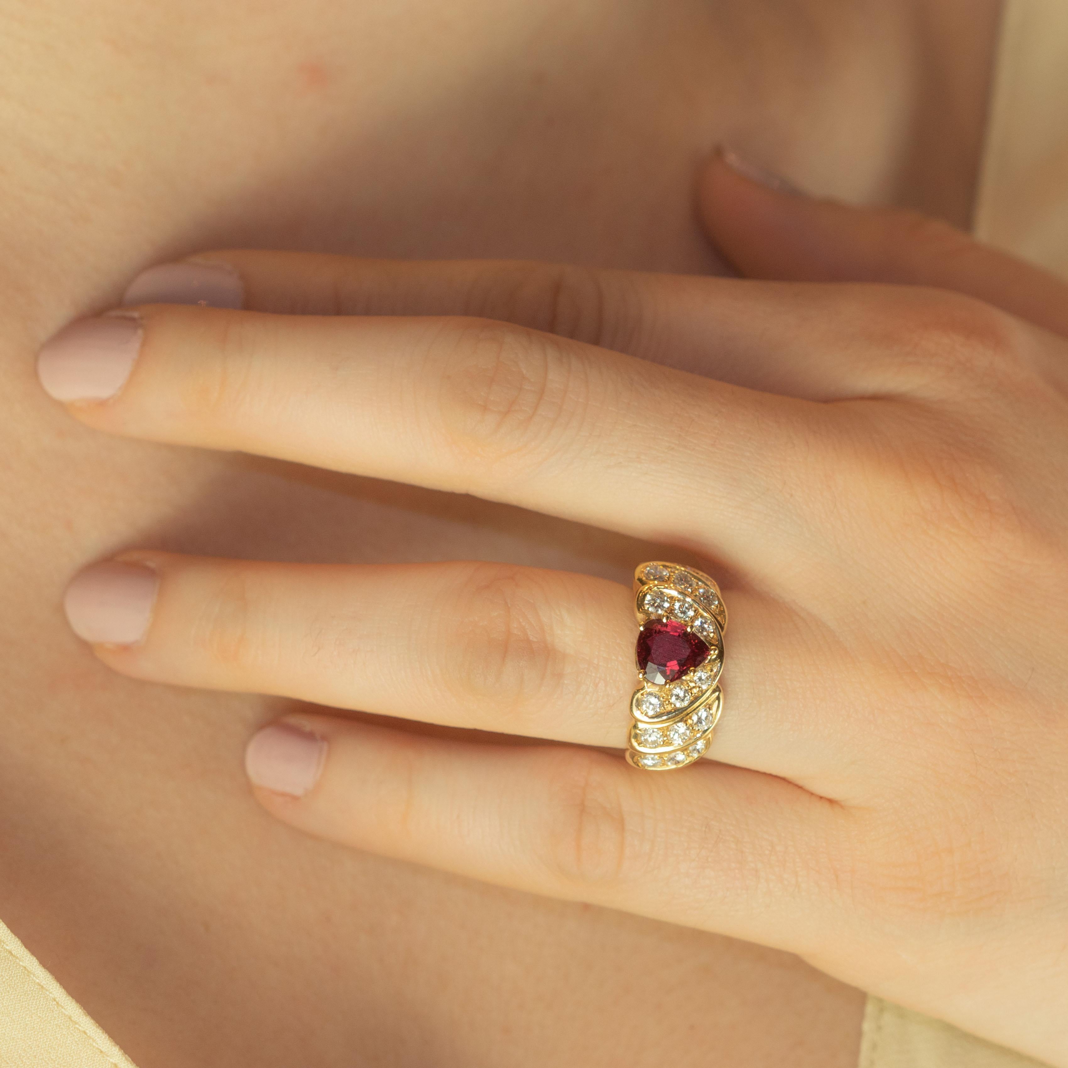 Iconic and modern gold ring with a pear shape ruby and various dancing diamonds located in a romantic ballad. The delicate 18 karat gold threads surround the fine stones in a swing creating a subtle and delicate woven.

• 18k yellow gold (10.7 g)
•