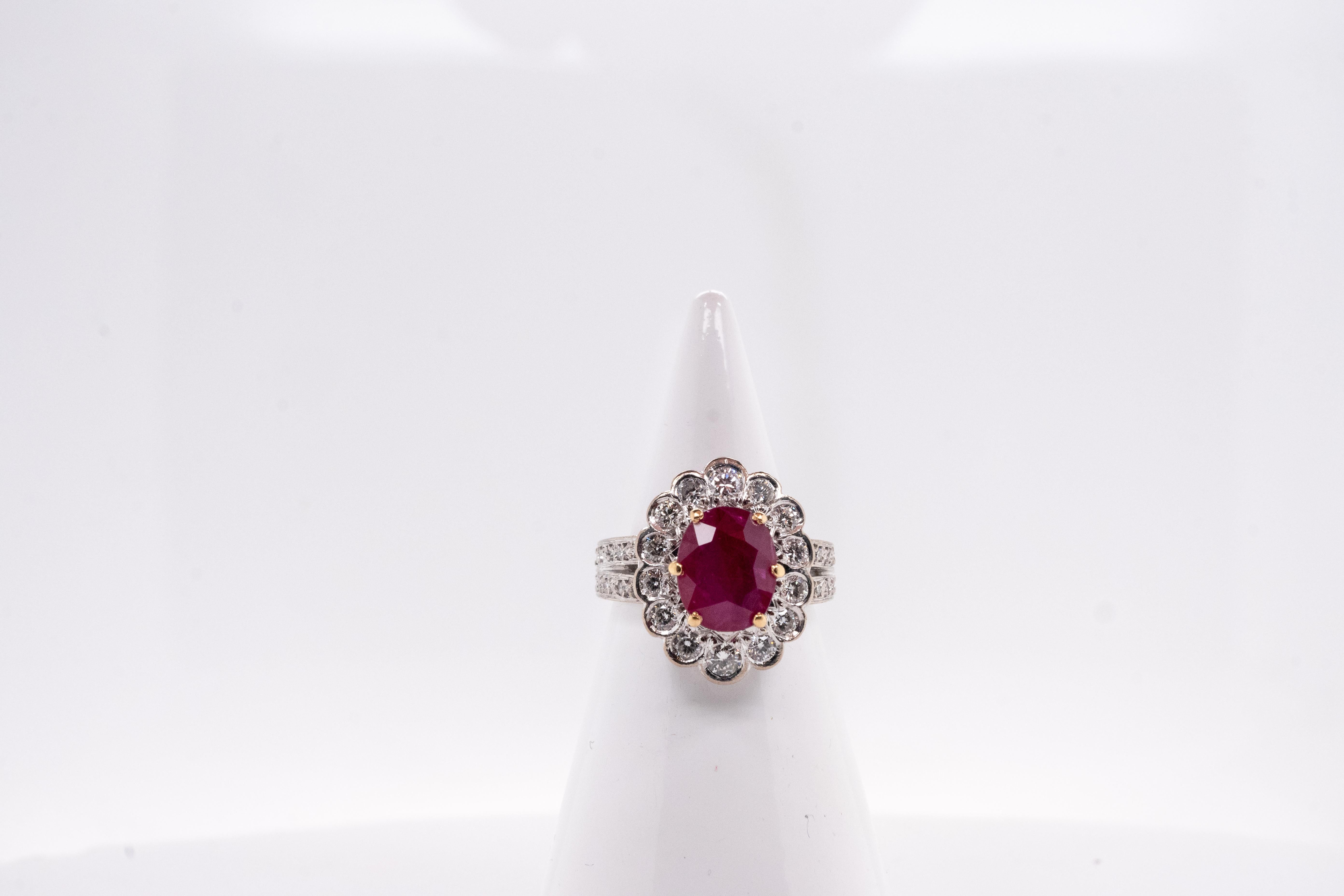 Discover the elegance of our white gold ring, featuring refined design with the splendor of precious stones. This ring is adorned with a captivating 2.85-carat ruby, adding a touch of vibrant color. The 6 yellow gold claws set the oval-cut ruby.