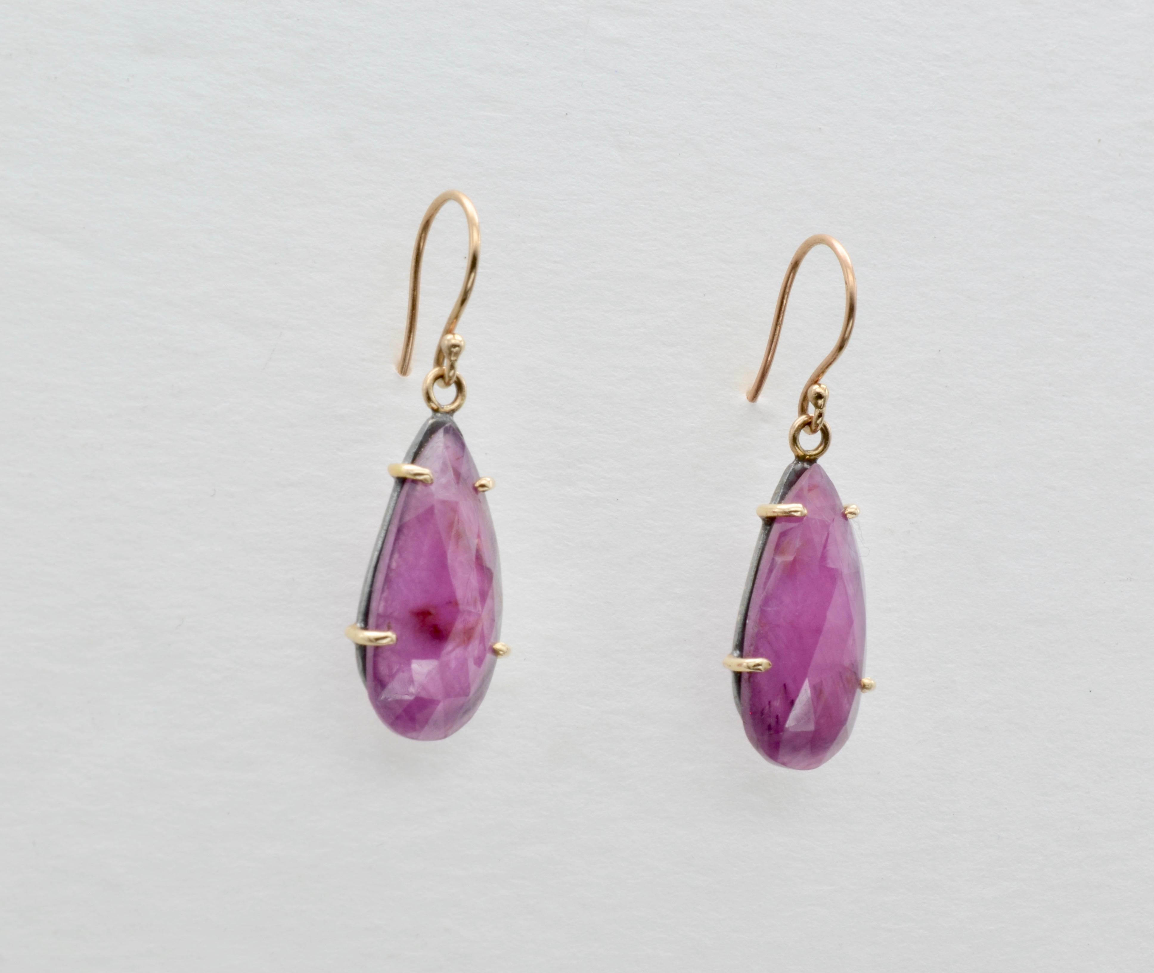 These ruby earrings are modern and lovely. The rubies are rose cut and set in oxidized sterling silver with 14k gold prongs and ear wires. The drop earrings are fun and can be worn for any occasion. 