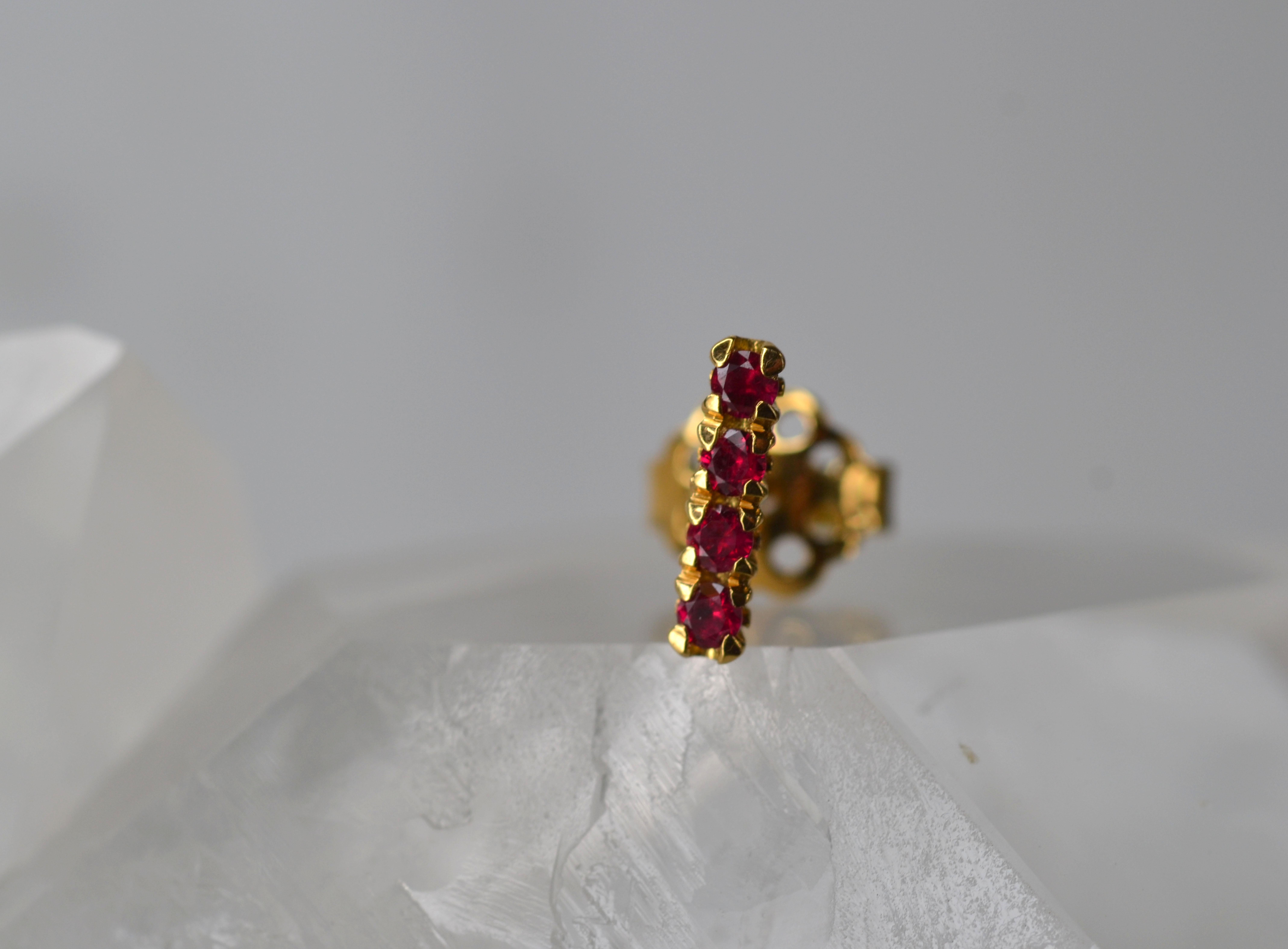 This single earring stud is part of our Blossom Collection of mix and match pieces. The vibrant rubies are set on an 18k gold blossom flower collet to be worn alongside your favourite pair of earrings, our blossom hoops, or combine with any other