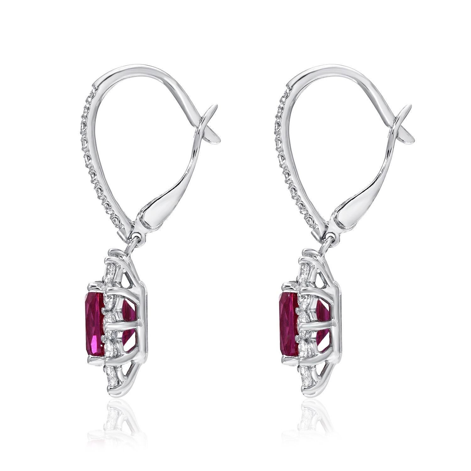 Vibrant pair of certified vivid pinkish-red Rubies, weighing a total of 2.84 carats, adorned by round brilliant diamonds weighing a total of 1.28 carats, in 18K white gold lever back earrings.
Approximately 1