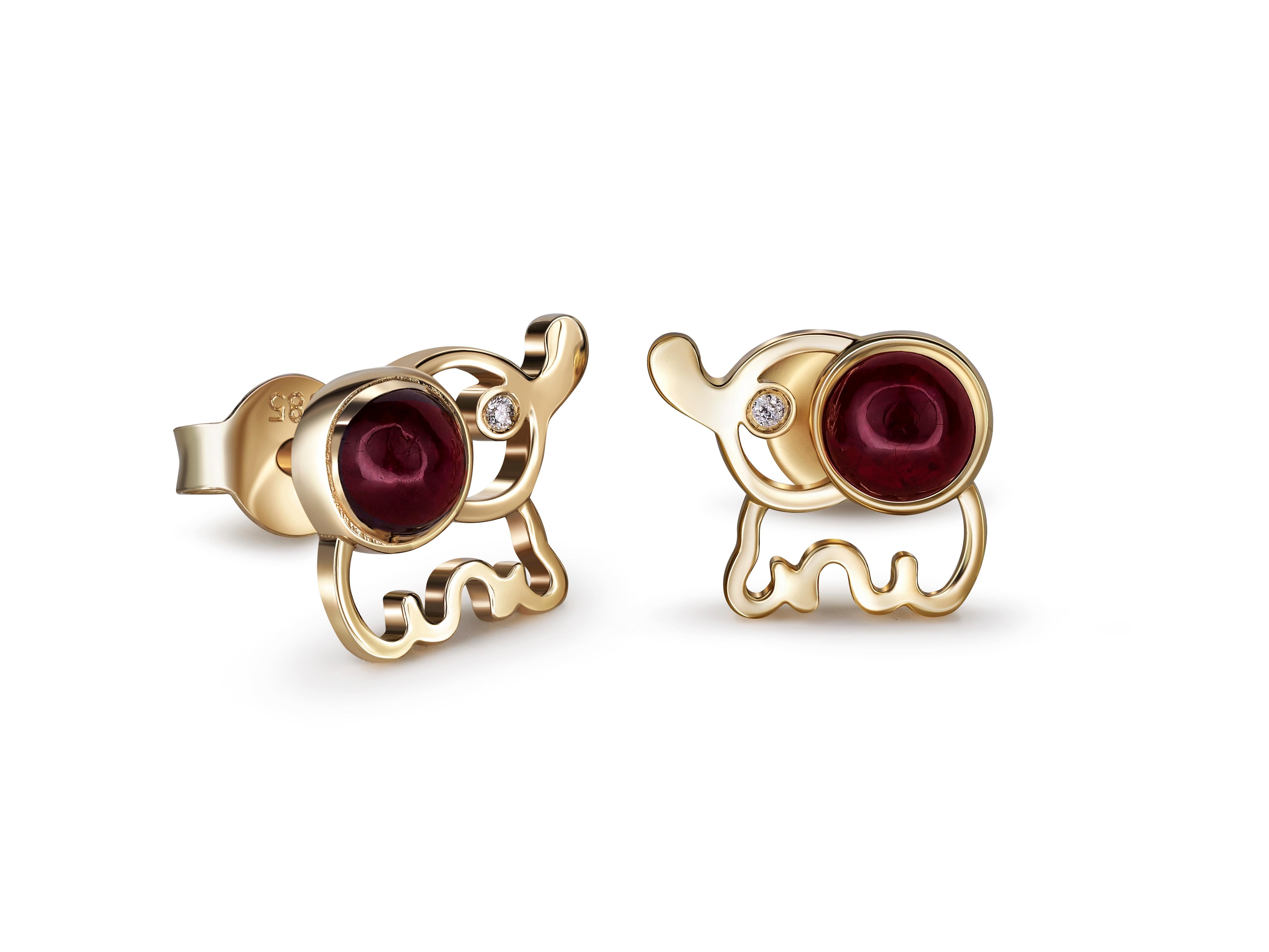 14 kt solid gold elephant earrings studs with natural ruby cabochons. Ruby birthstone.
Total weight: 2.2 g.
Size: 7 x 8 mm.
Central stones: Natural rubies - 2 pieces
Weight: approx 0.85 ct total (4 mm each), cut - round cabochon
Color: deep